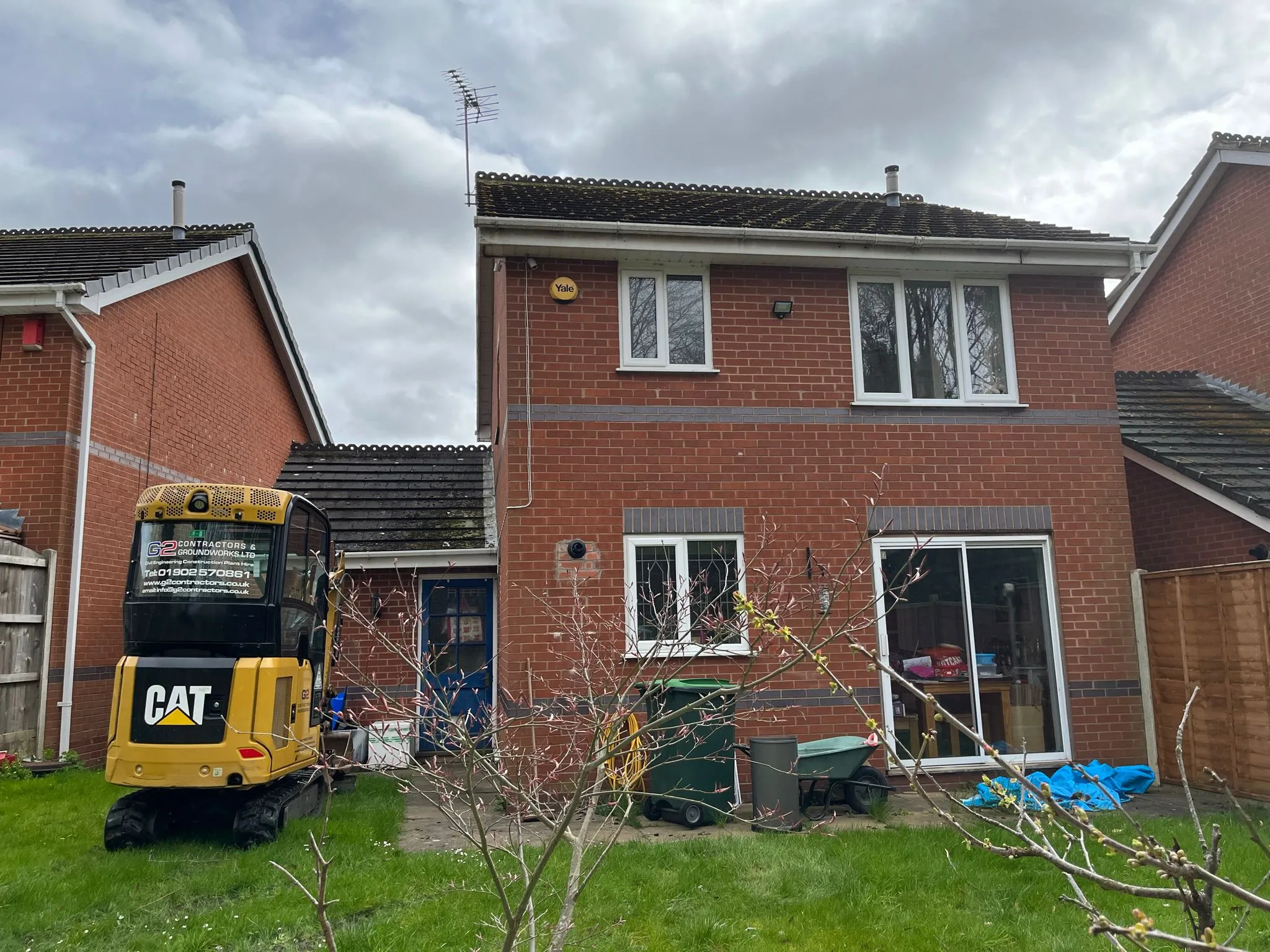 A mini-excavator starting the groundwork for a home extension in Dudley.