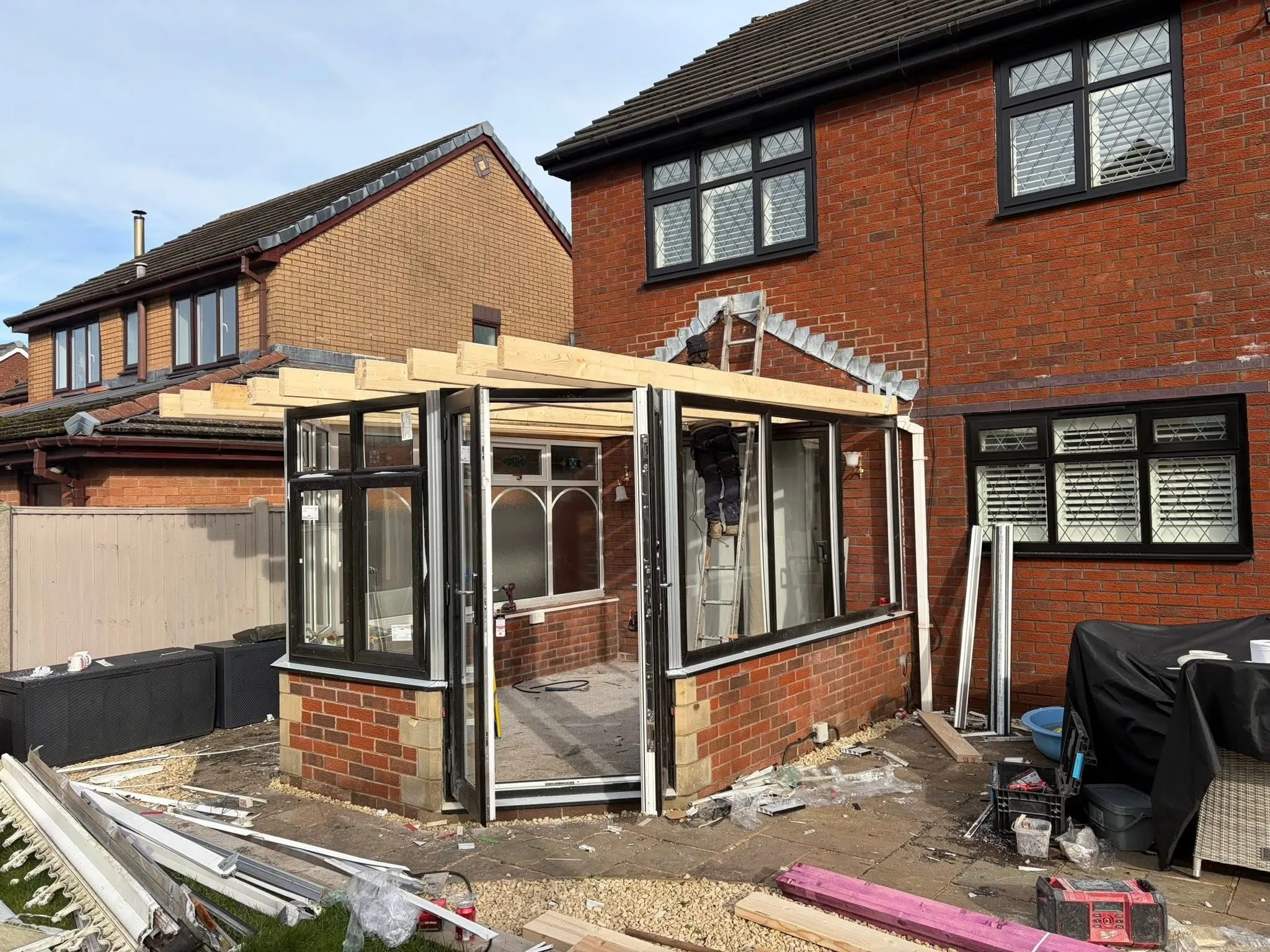 A professional solid conservatory roof conversion being installed by Lancashire Roofing Specialist in Blackburn.