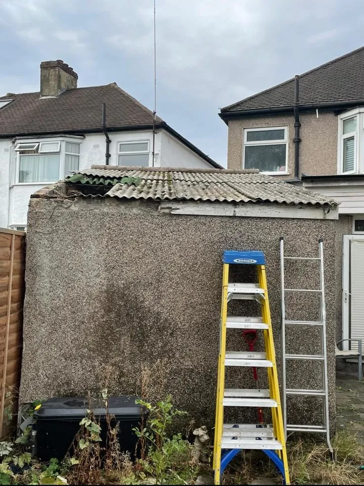 Damaged asbestos corrugated roof on a garage in Southampton