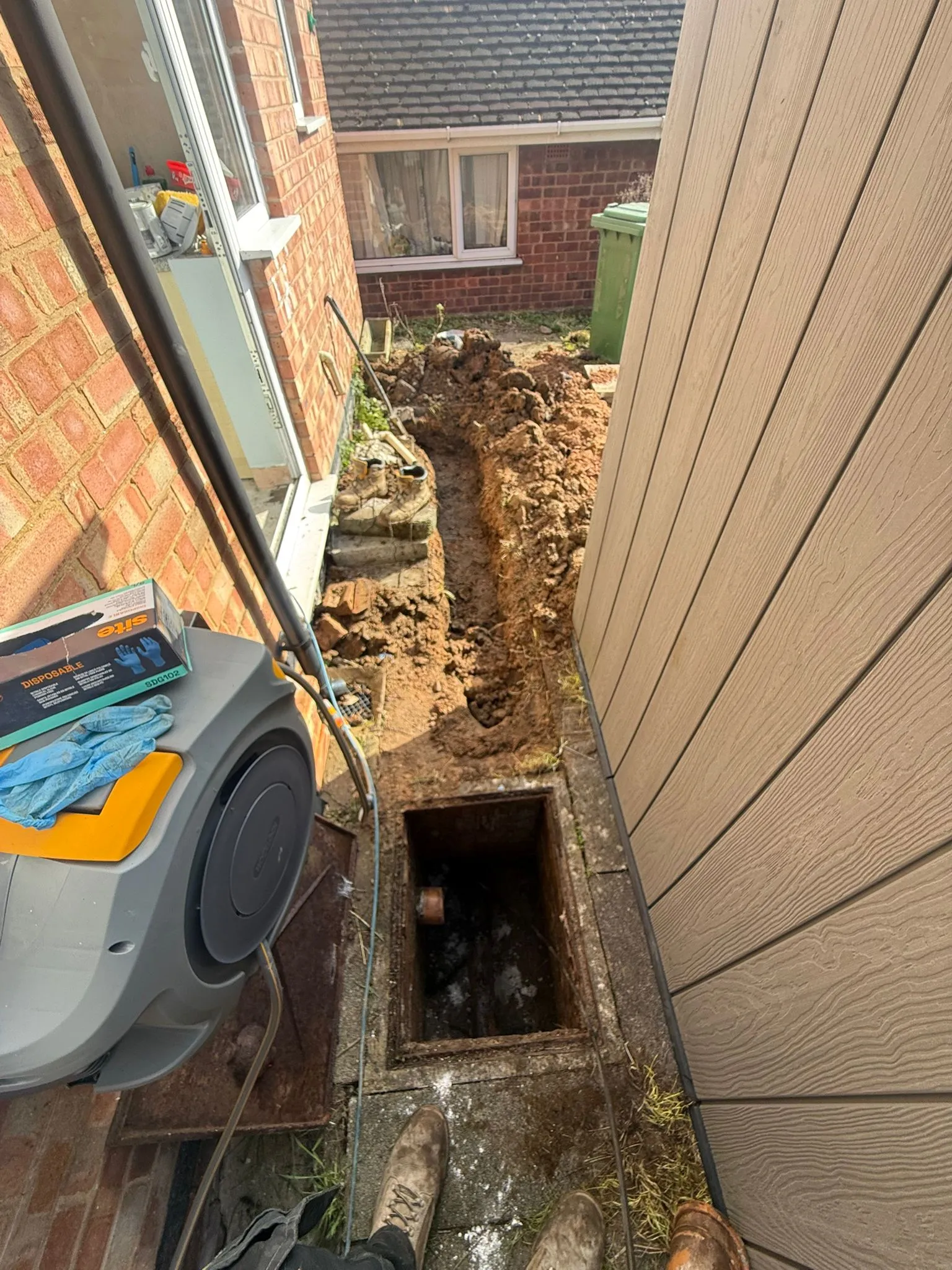 Traditional excavation for drain repairs and pipe replacement at a home in Bournemouth.