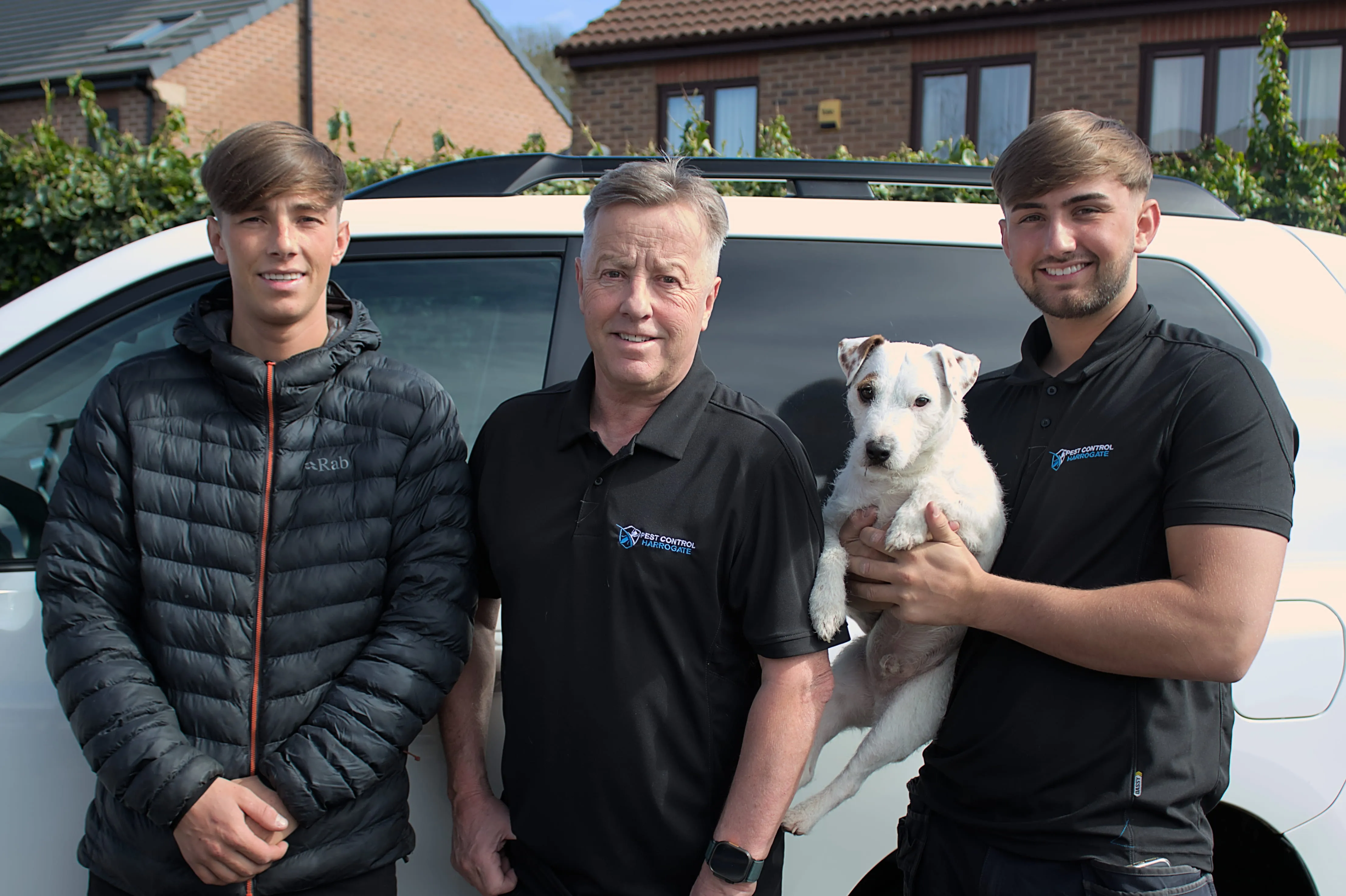 The professional team at Pest Control Harrogate standing in front of a company van in a residential North Yorkshire neighborhood.