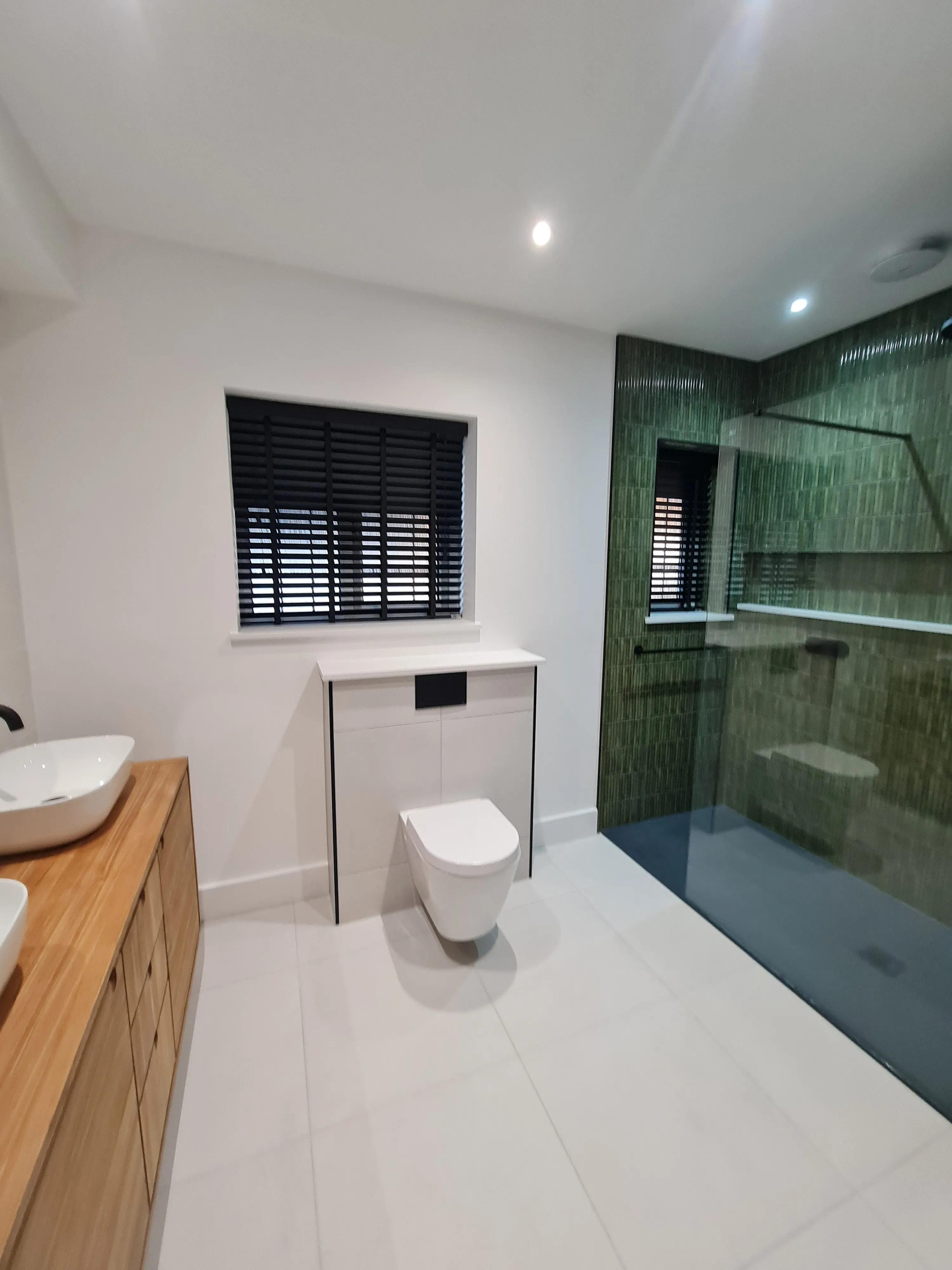 Luxury bathroom installation in Plymouth by Sands & Vossen featuring a walk-in shower and modern bespoke design.