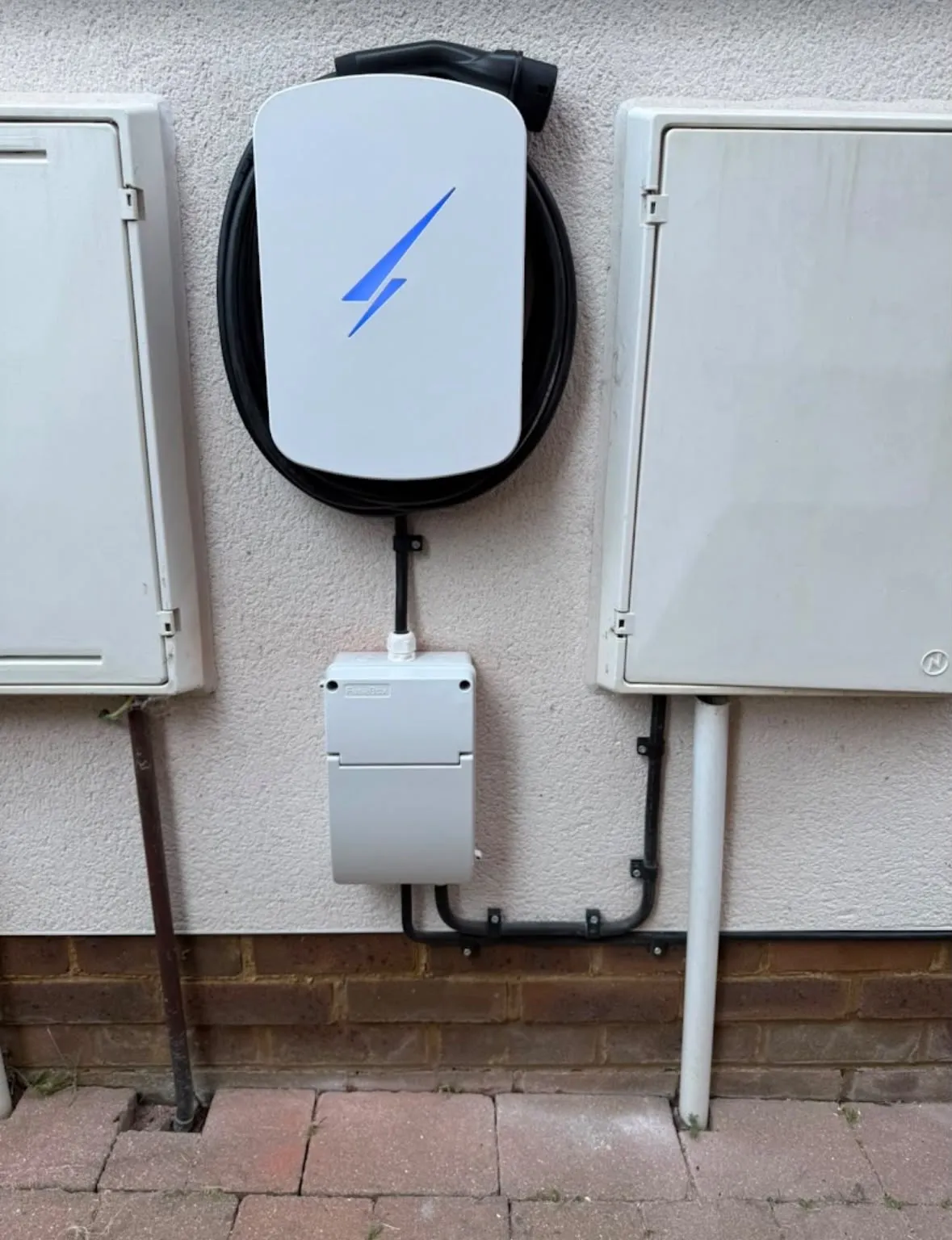 Domestic EV charger installation on an external property wall by Sussex Brown Sparks