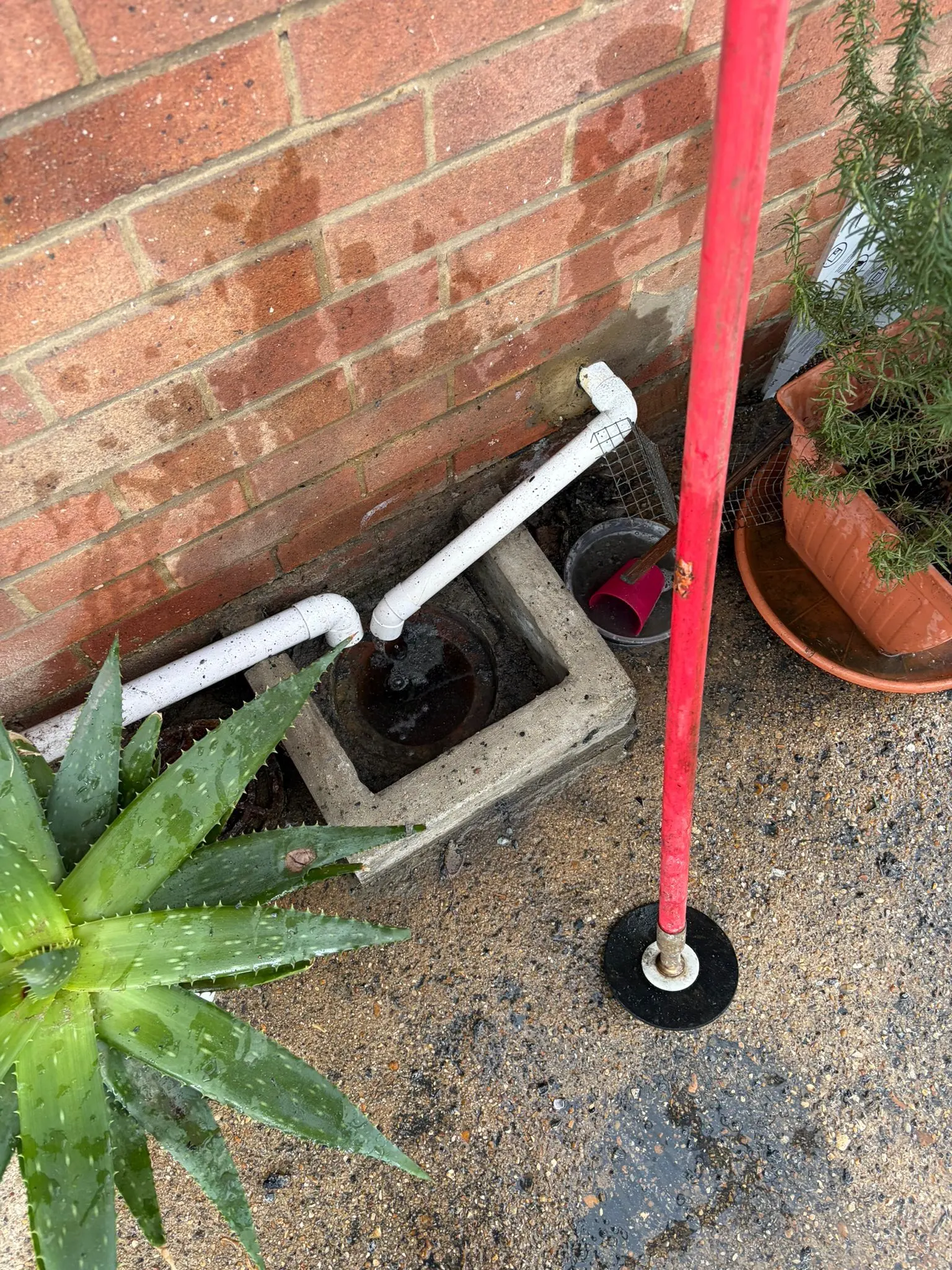 Blocked outside drain gully in Slough being prepared for unblocking.