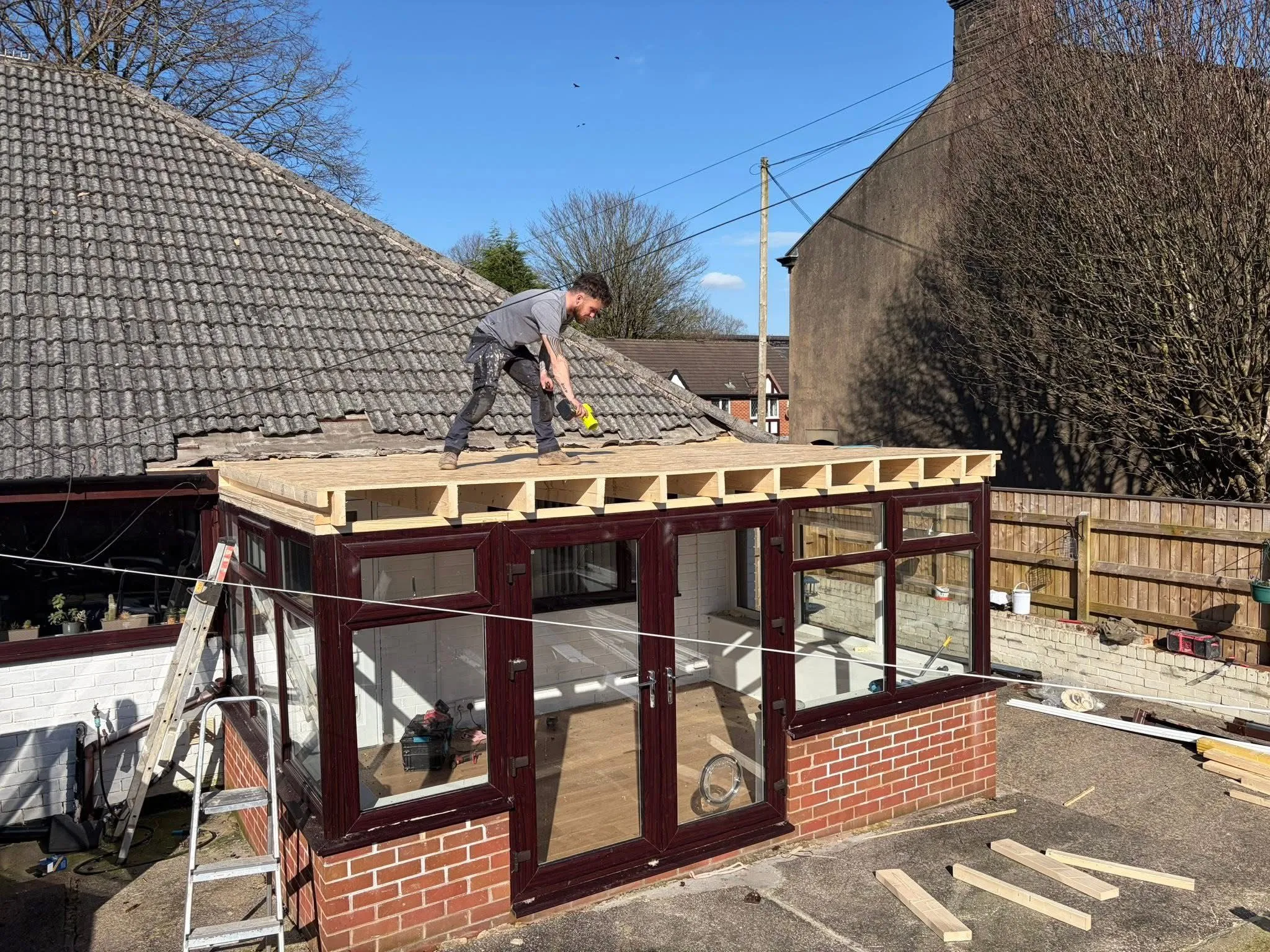 Roofer installing a solid conservatory roof conversion in Lancashire