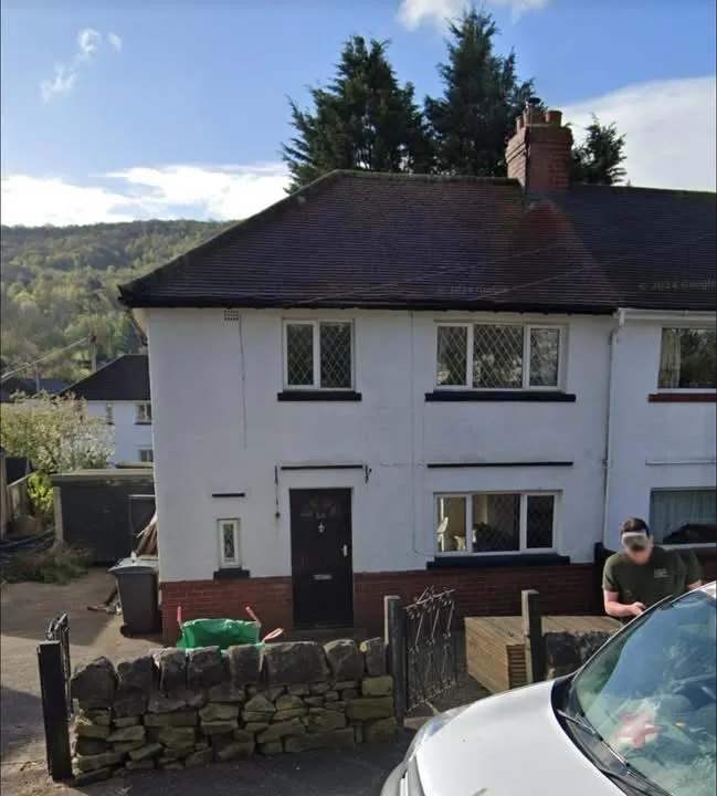 A semi-detached house with a brown tiled roof in West Yorkshire, showcasing local pitched roofing styles.