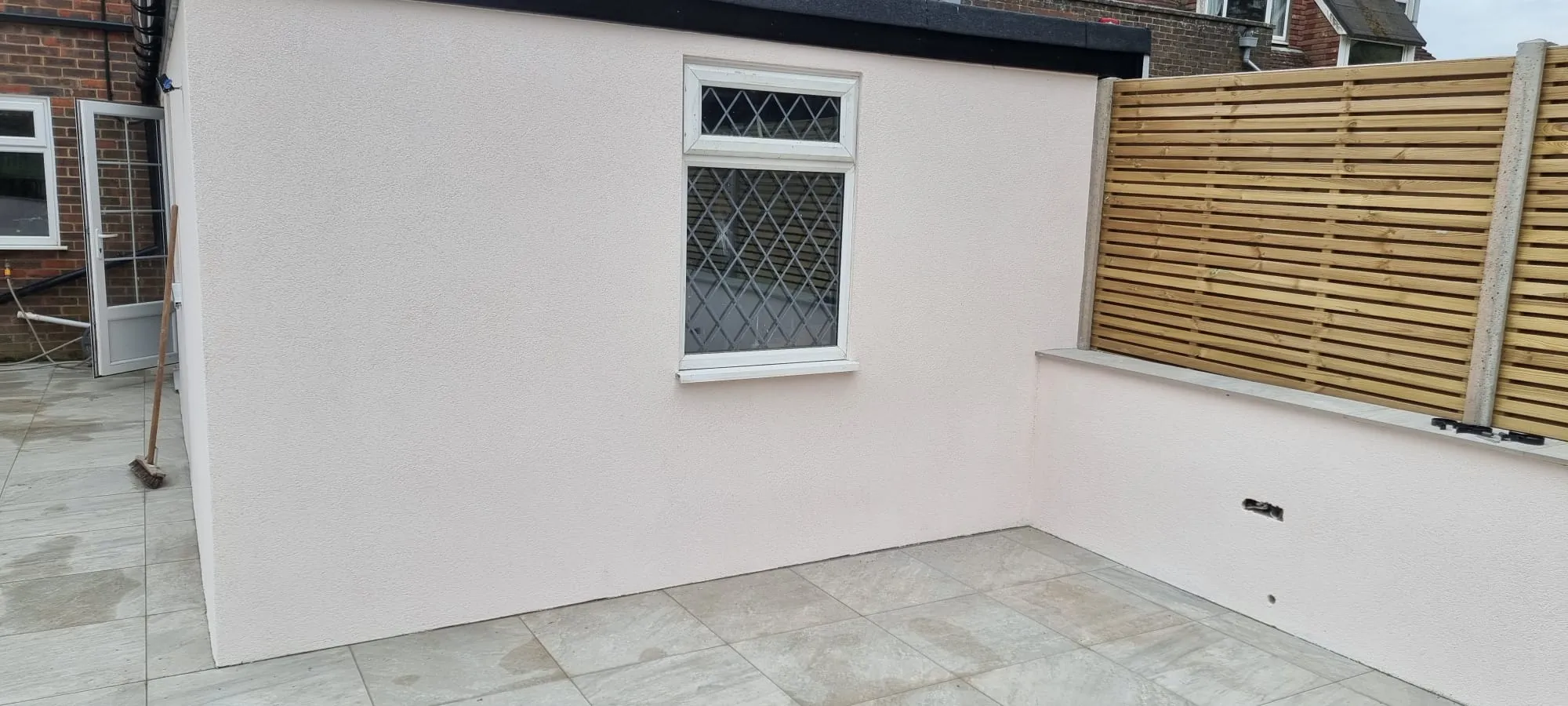 High-quality external rendering finish on a modern home extension, completed by Portslade Plastering.