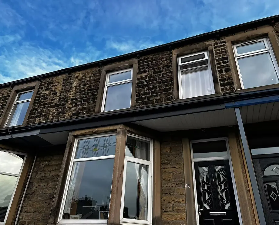 Exterior view of a traditional stone terraced house in Burnley showing clean brickwork pointing