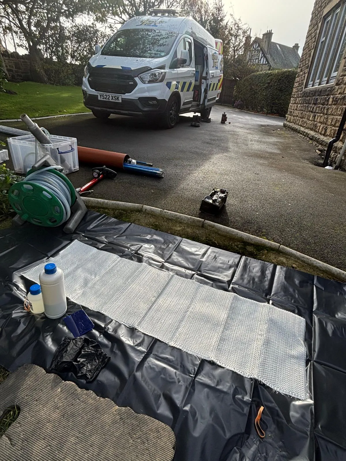 Drain Jet van and trenchless no-dig patch repair equipment on a driveway in Leeds