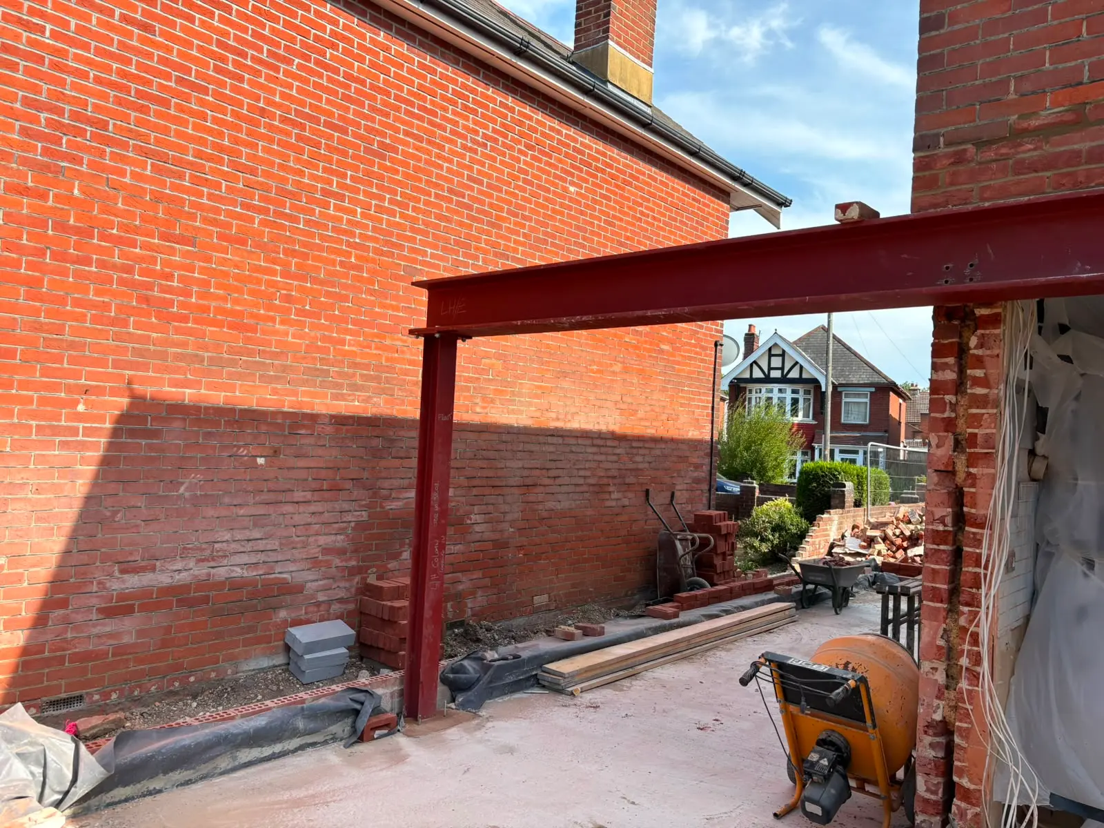 Structural RSJ steel beam and support post installation for a home extension by Aline Construction