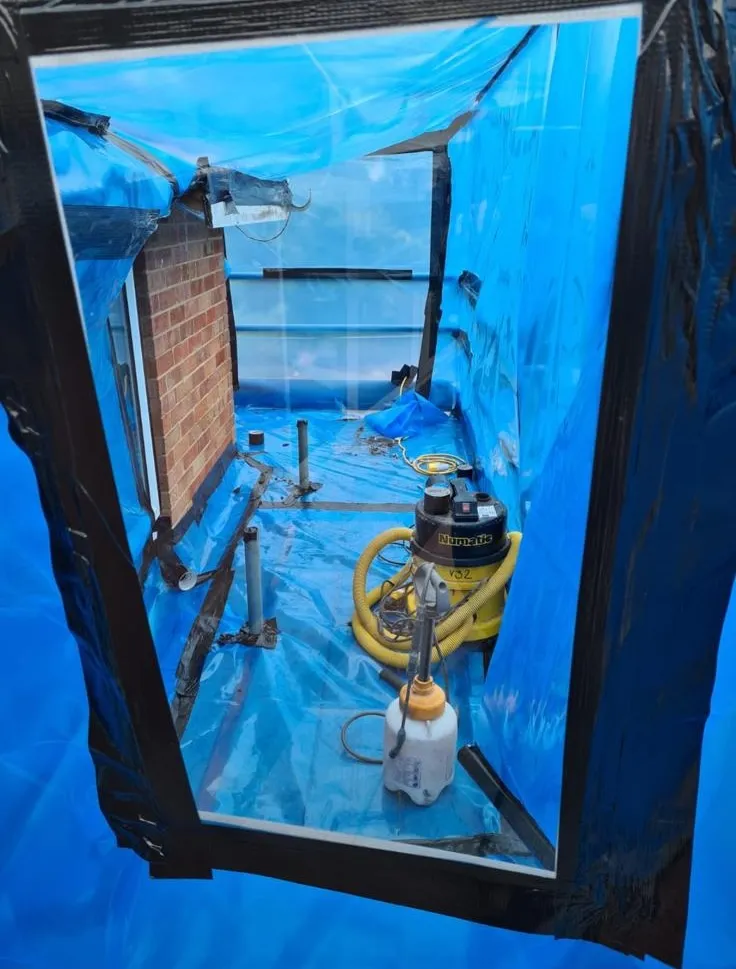 Professional asbestos removal containment enclosure with specialist equipment