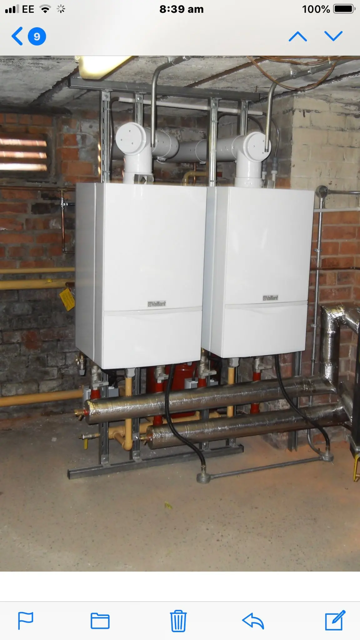 Two Vaillant commercial boilers installed side-by-side with insulated pipework in a basement plant room.