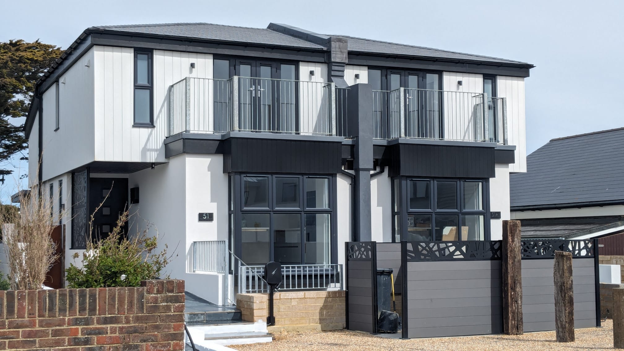 Modern house with professional white rendering and black cladding in Southwick