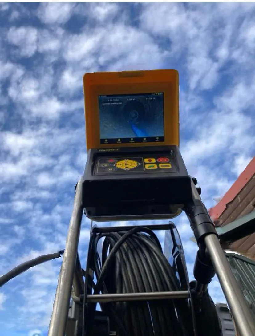CCTV drain survey camera system with a live feed of a drain's interior on the screen, ready for inspection