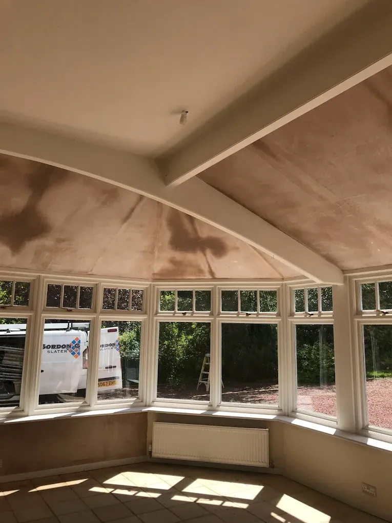 Newly plastered walls and ceiling drying in a sunroom, demonstrating professional interior plastering work in Lanark.