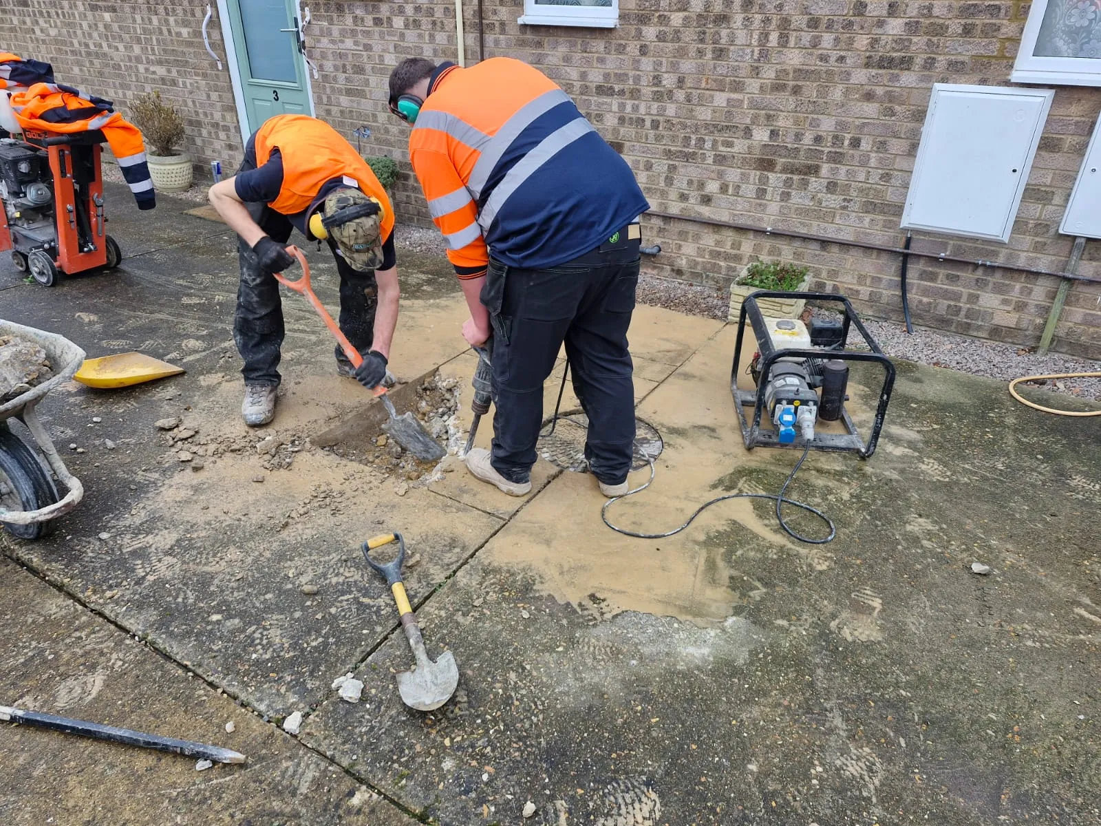 Engineers carrying out drainage excavation and civils groundworks.