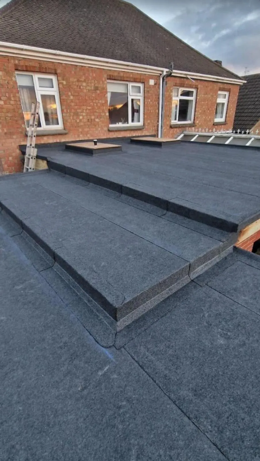 Multi-layer torch-on felt flat roof installation on a residential extension in Plymouth