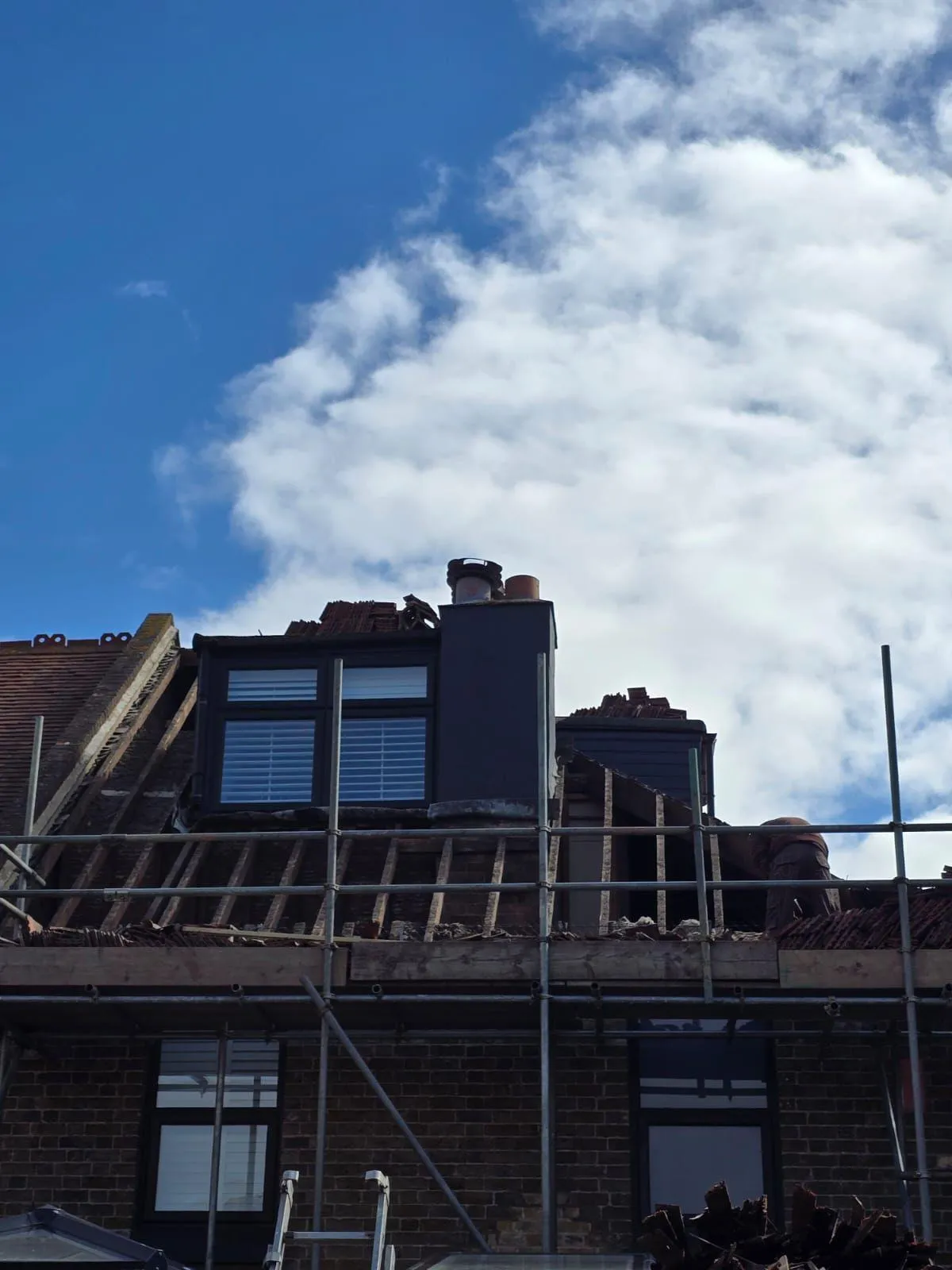 Pitched roof replacement and timber rafters exposed during re-roofing work on a residential home in Kent