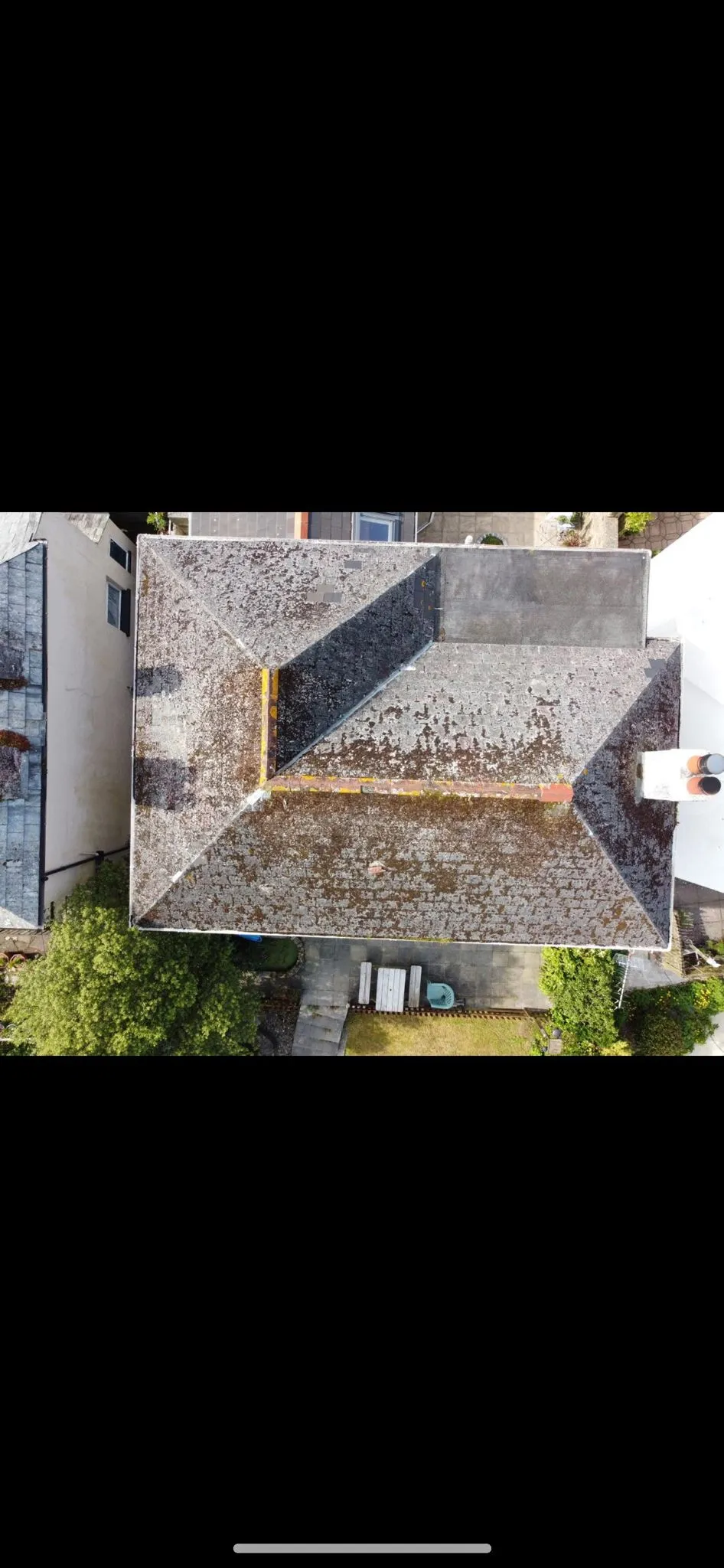 Aerial drone roof survey of a domestic property in Cornwall with heavy moss coverage.