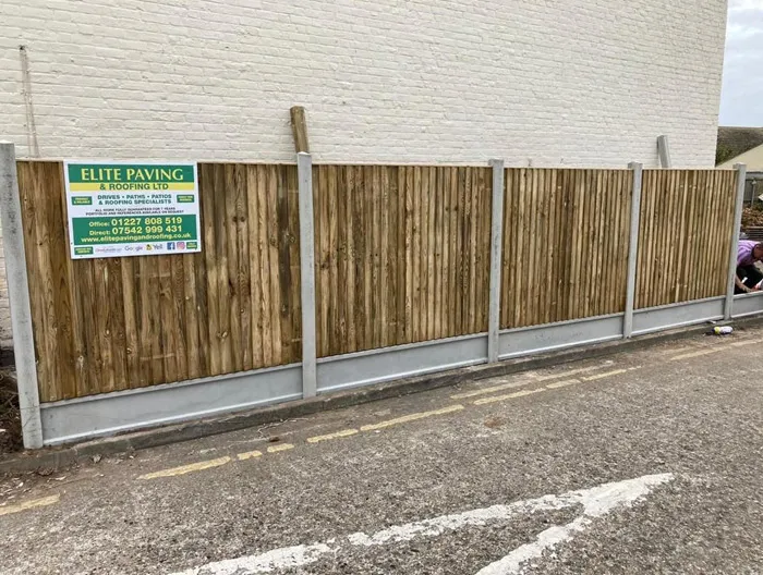 Newly installed wooden fence with concrete posts and gravel boards by Elite Paving & Roofing LTD