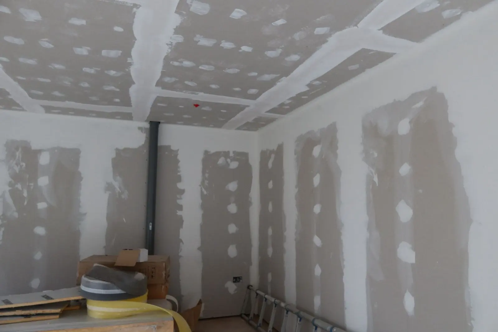 Taped and jointed plasterboard ceiling and walls during an internal wall insulation finishing process
