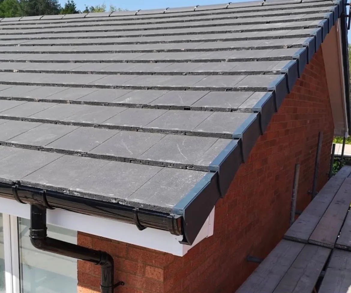 Pitched tiled roof replacement with modern dry verge system and black guttering by Tonbridge and Malling Roofing