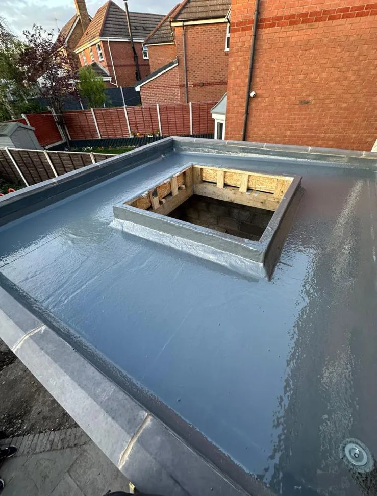 Newly installed grey GRP fibreglass flat roof with a waterproofed timber upstand for a skylight