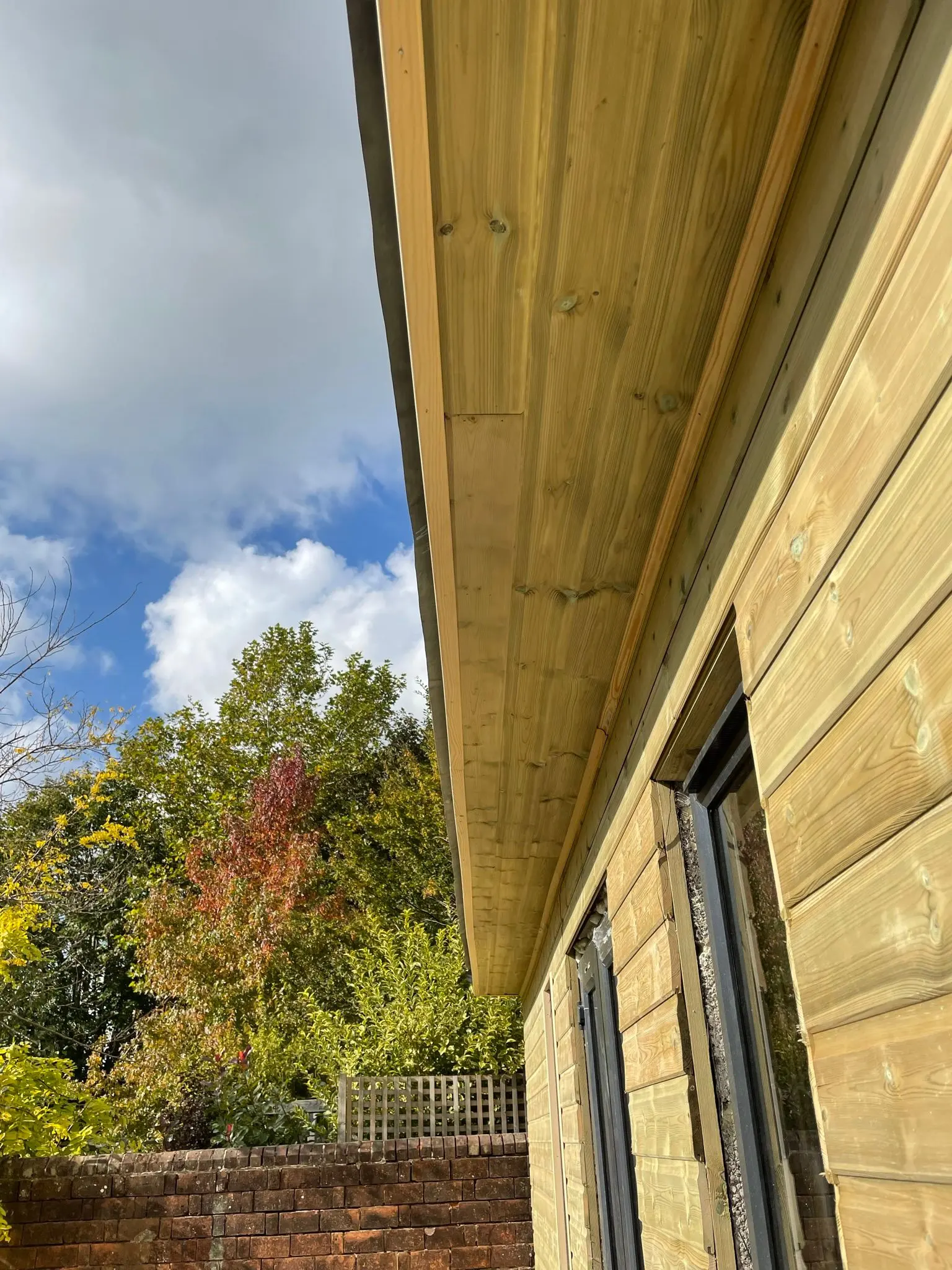 A close-up view of a wooden garden room being built
