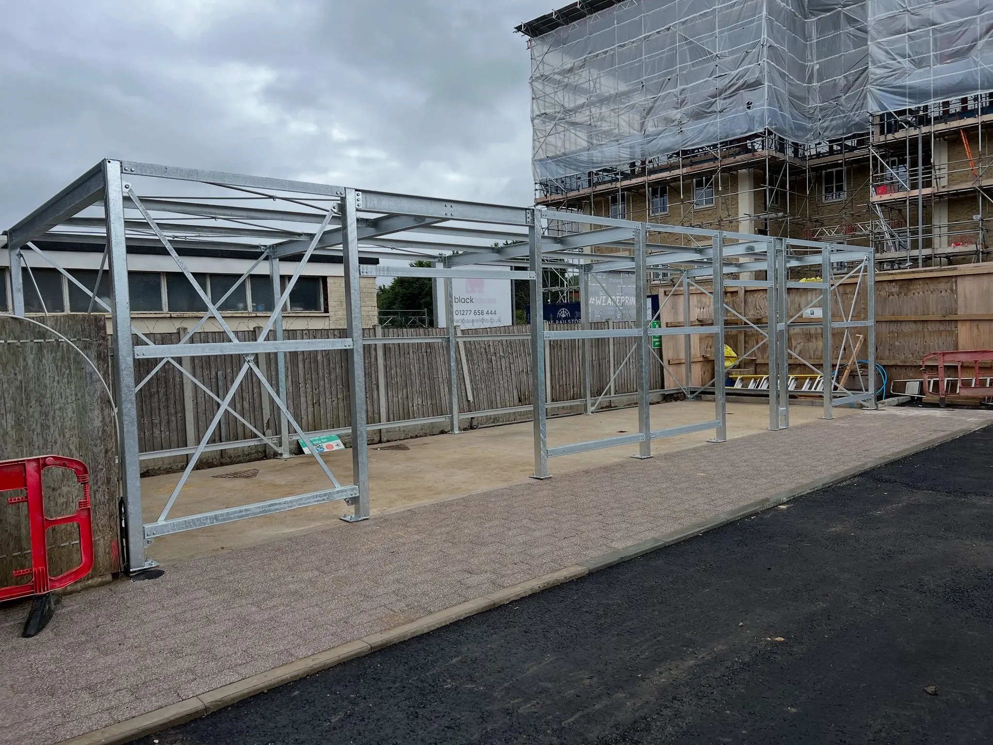 Galvanised steel frame erection for a new commercial unit, demonstrating professional structural installation on a concrete foundation.