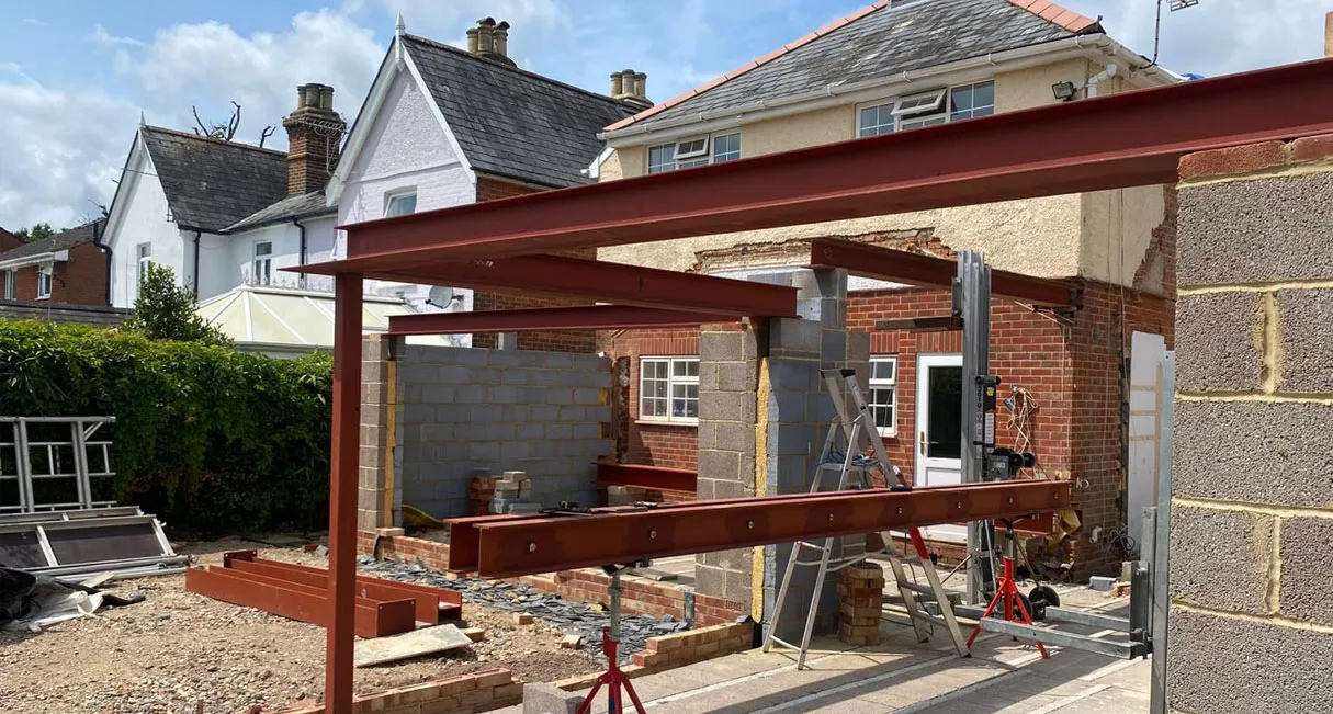 Installation of structural steel beams and RSJs for a home extension building project.