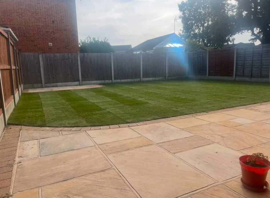 A professionally landscaped garden in Essex featuring a sandstone patio and high-quality turf.