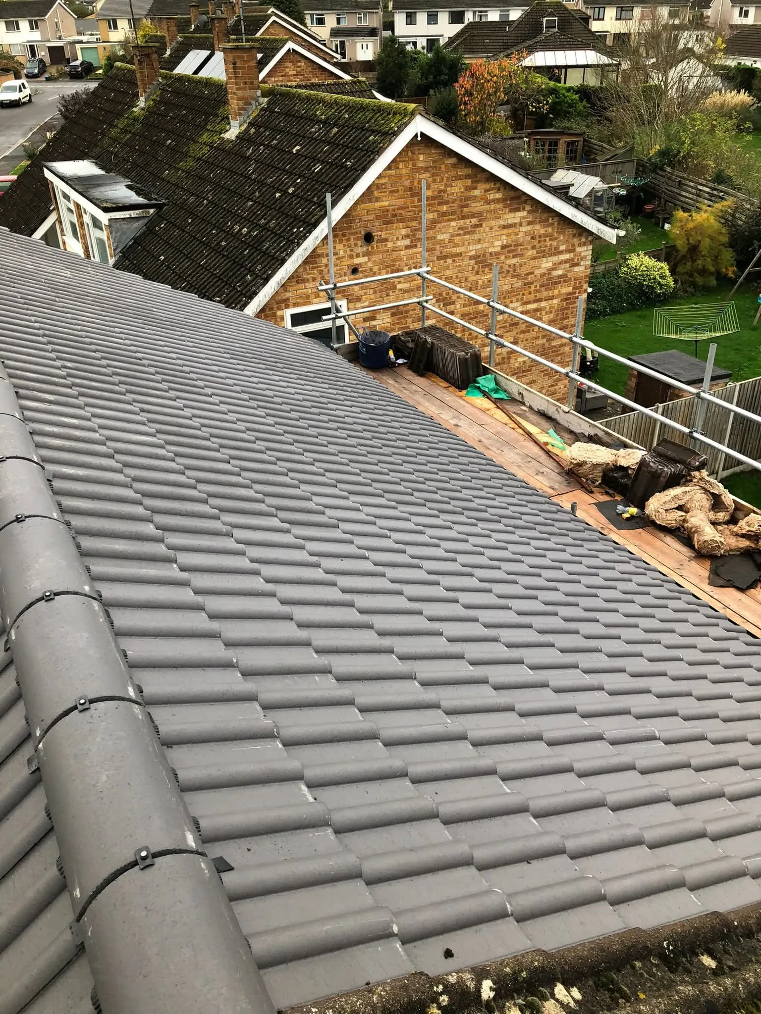 New grey roof tile installation on a domestic property by South West and Wales Roofing (NTL Roofing).
