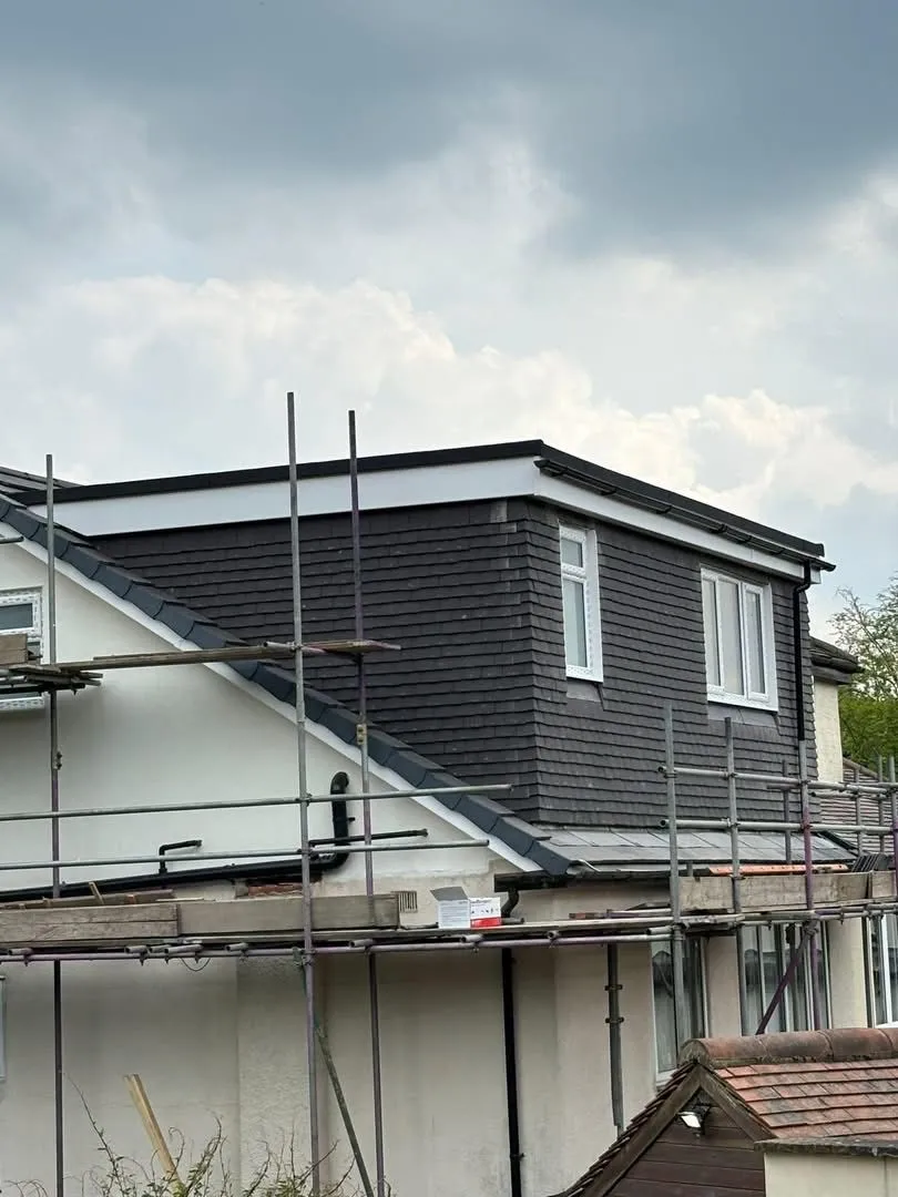 New dormer roof installation with slate tiling and white fascias by Renovation Roofing Ltd in Leeds.