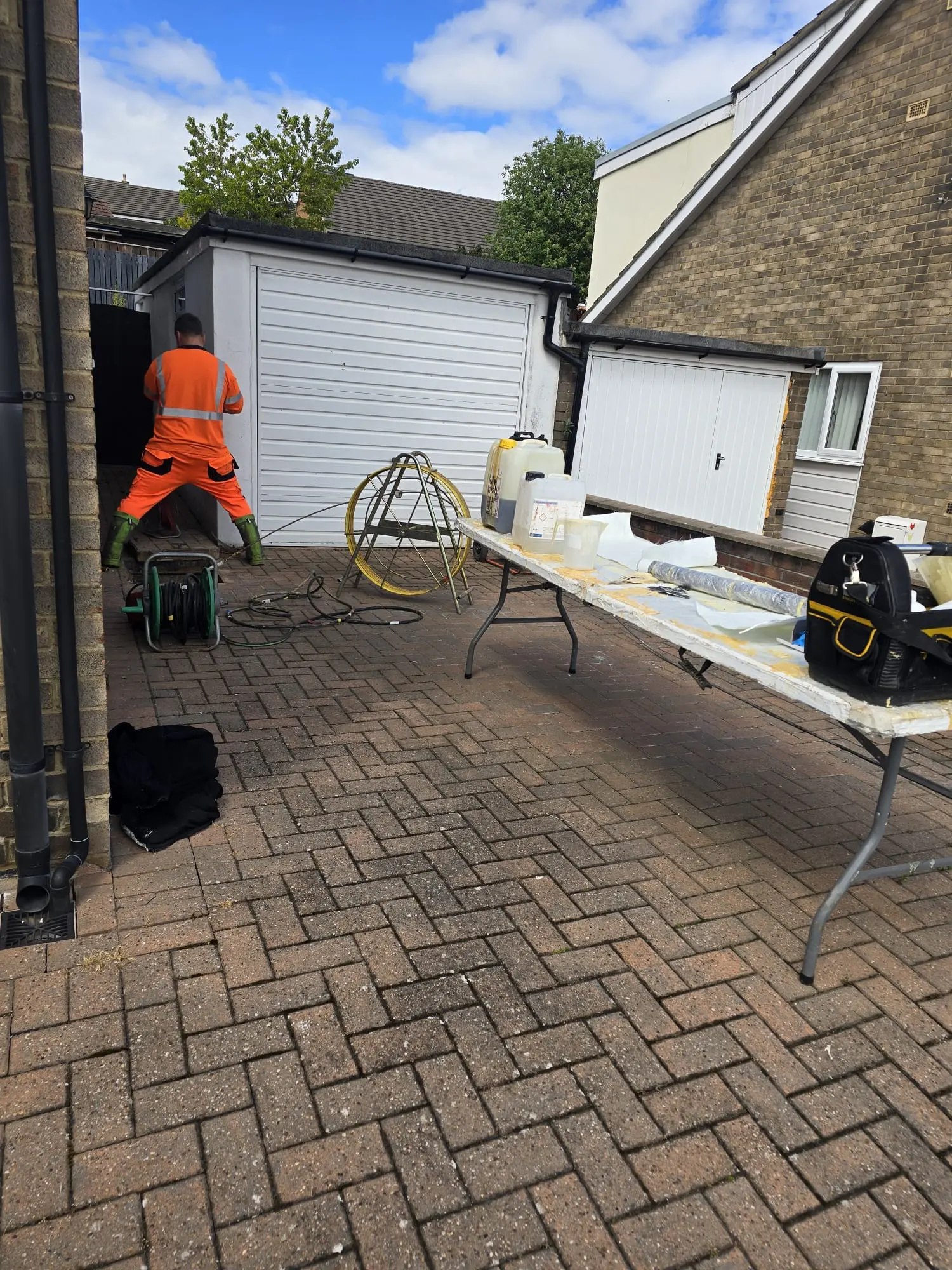 APJ Drainage engineer preparing materials for no-dig drain relining on a residential driveway in the North East