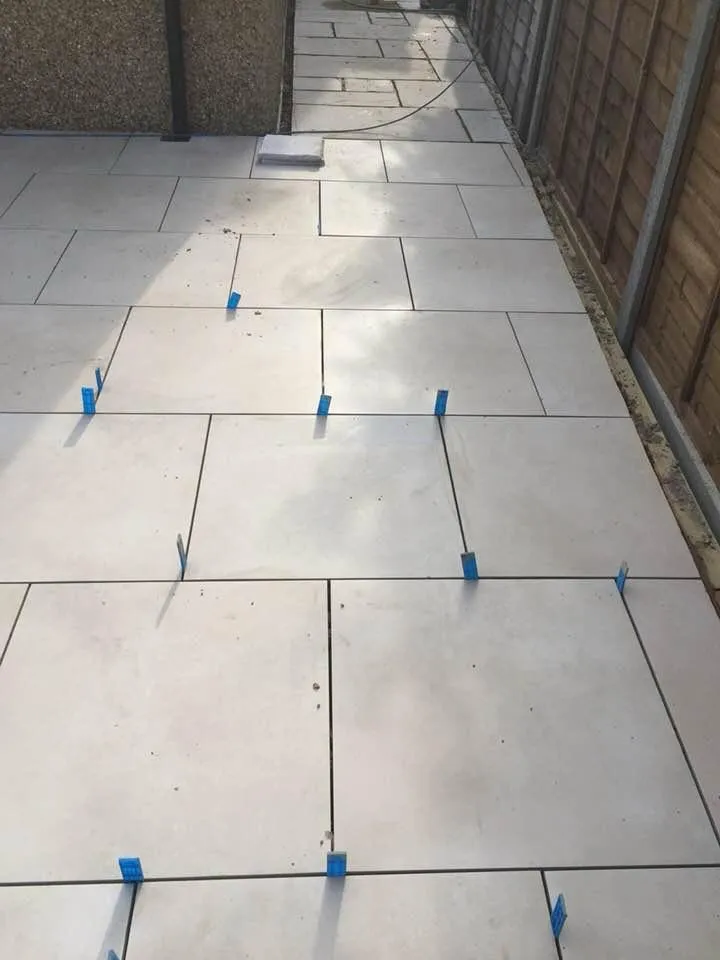 Modern porcelain paving being installed for a garden patio in South-East London.