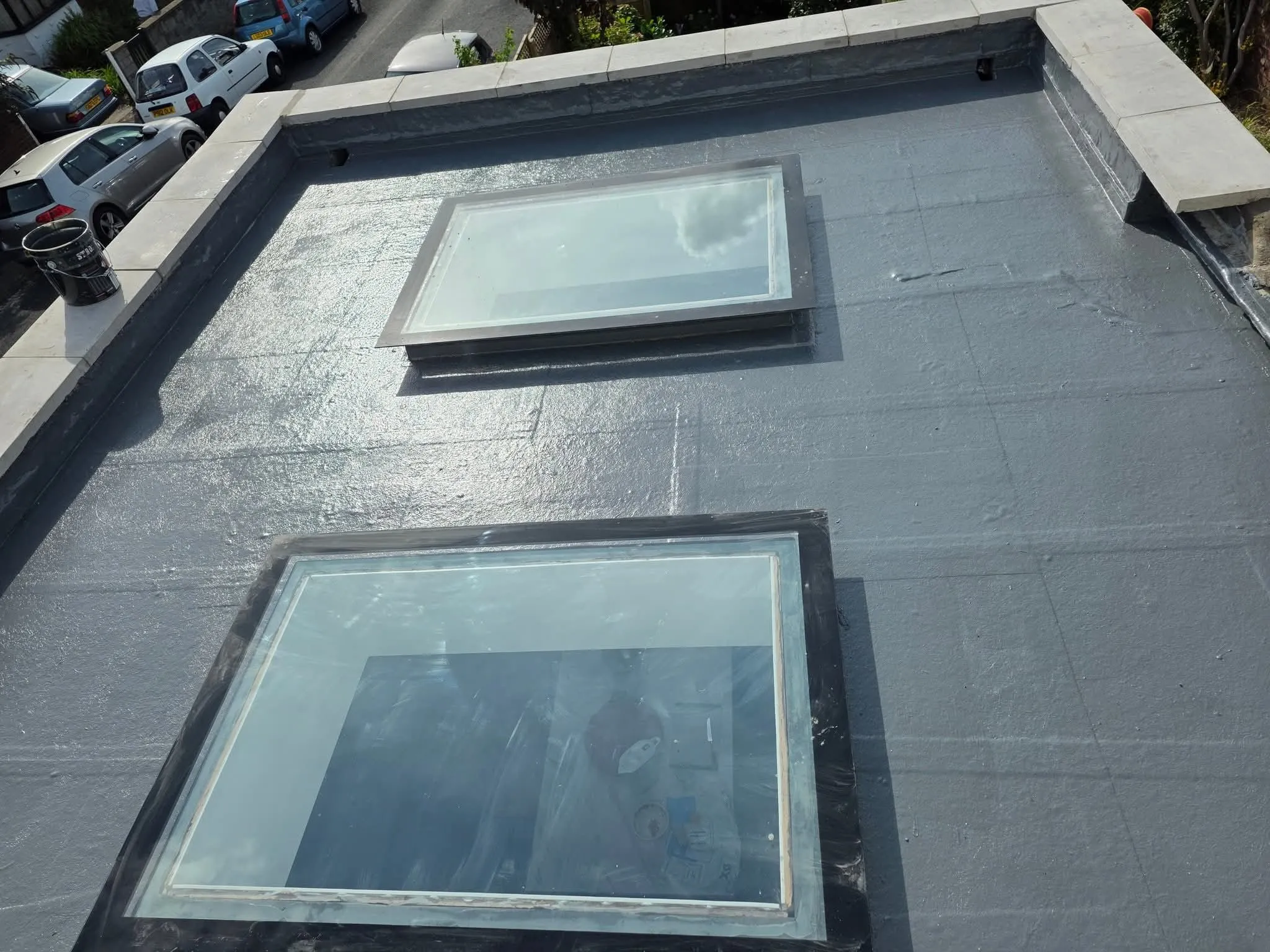 Professional flat roofing installation with skylights in Swindon by NTL Roofing.