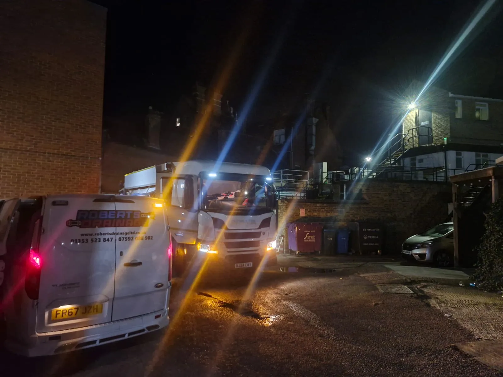 Roberts Drainage Ltd van and tanker providing 24/7 emergency drainage services at night