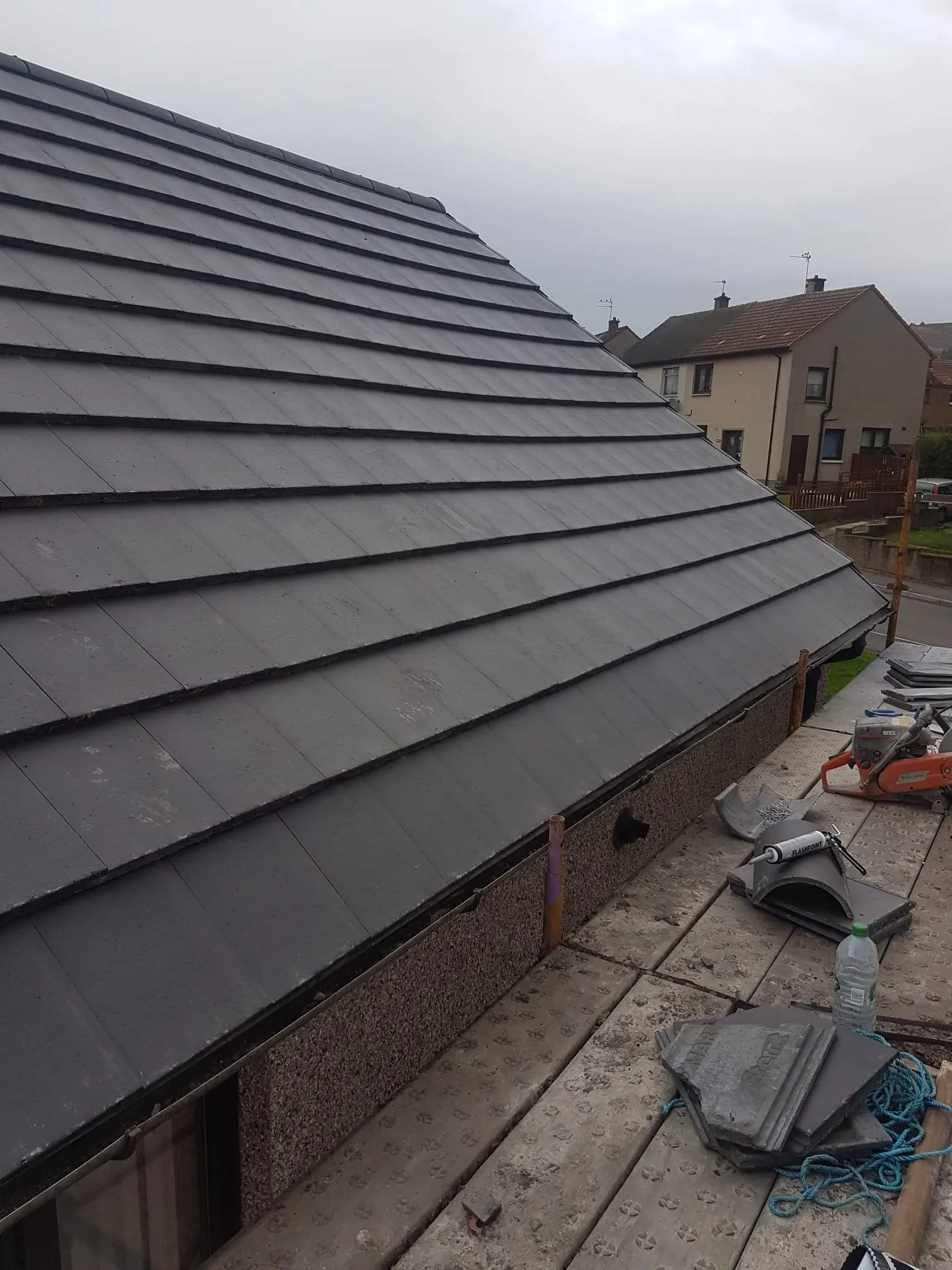 Newly installed grey tiled roof on a residential property