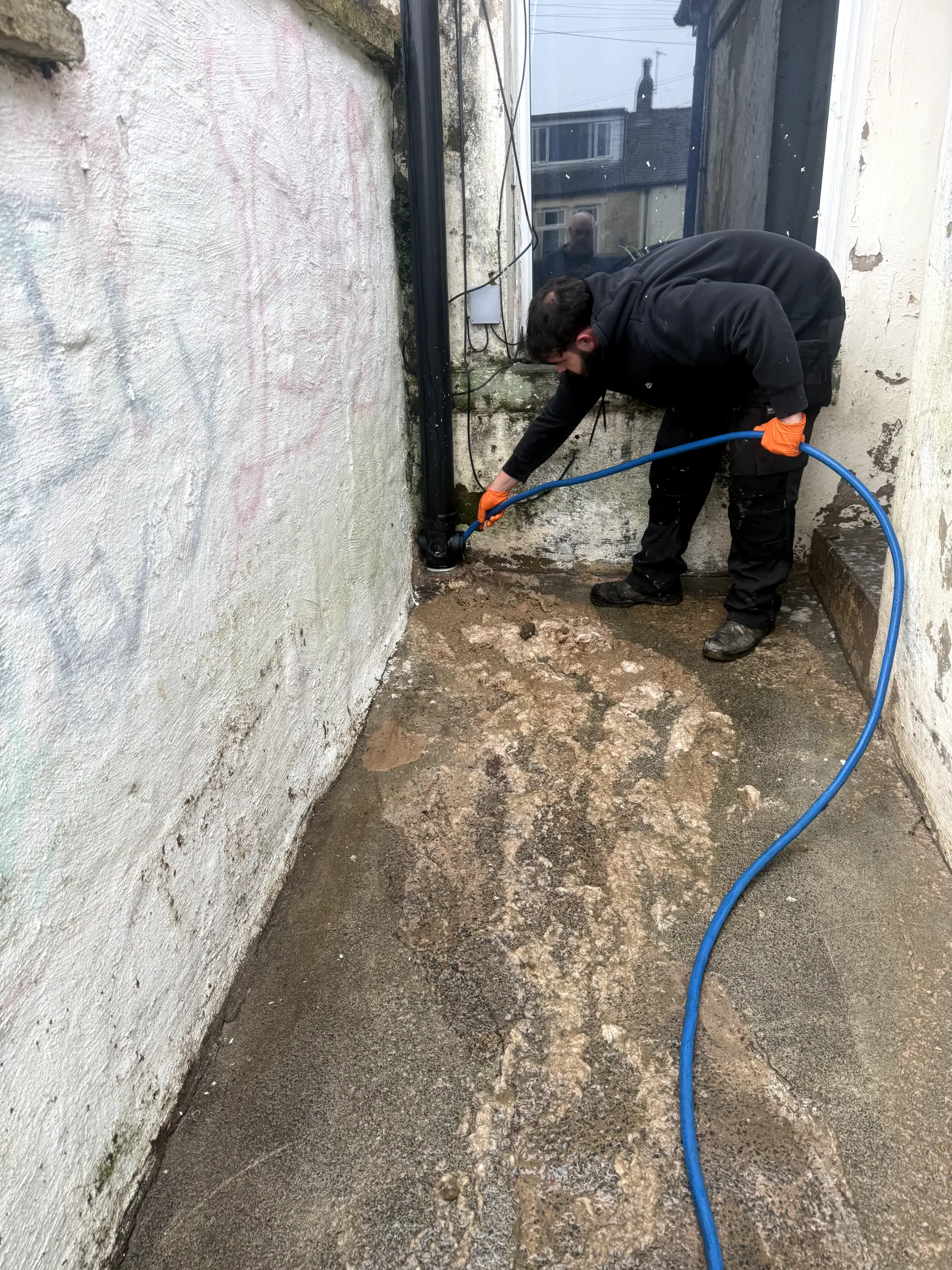 WGS Services engineer performing high-pressure water jetting to unblock a domestic drain in Darwen