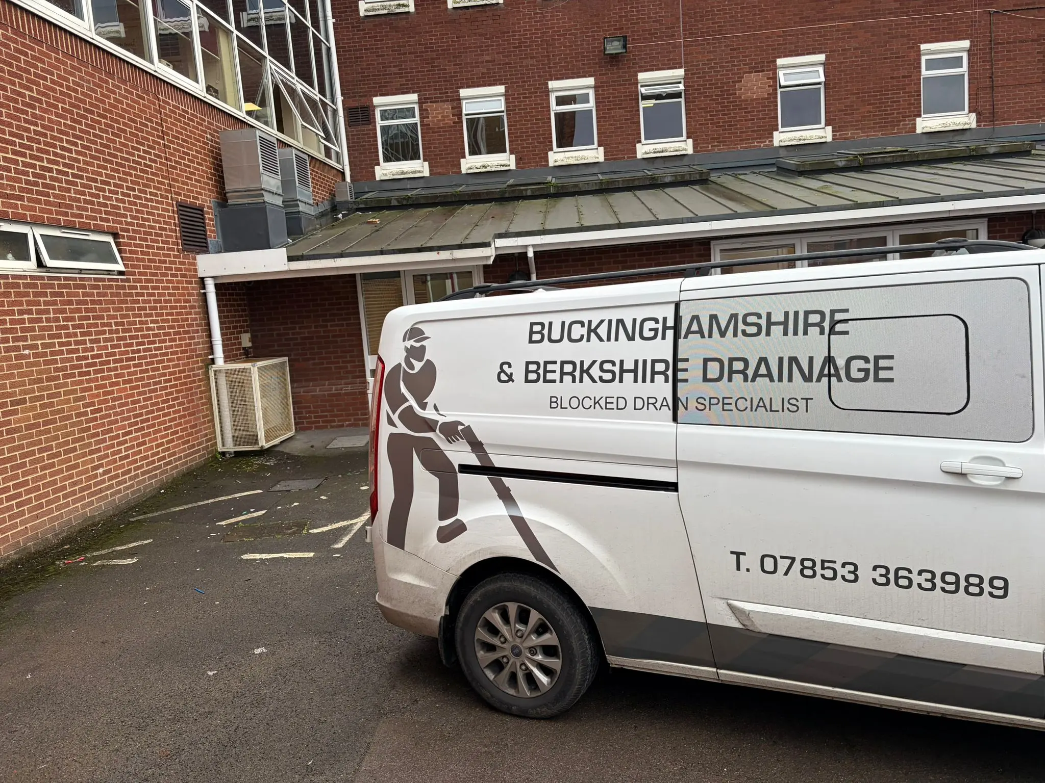 Buckinghamshire & Berkshire Drainage service van parked in front of a commercial property in Slough.
