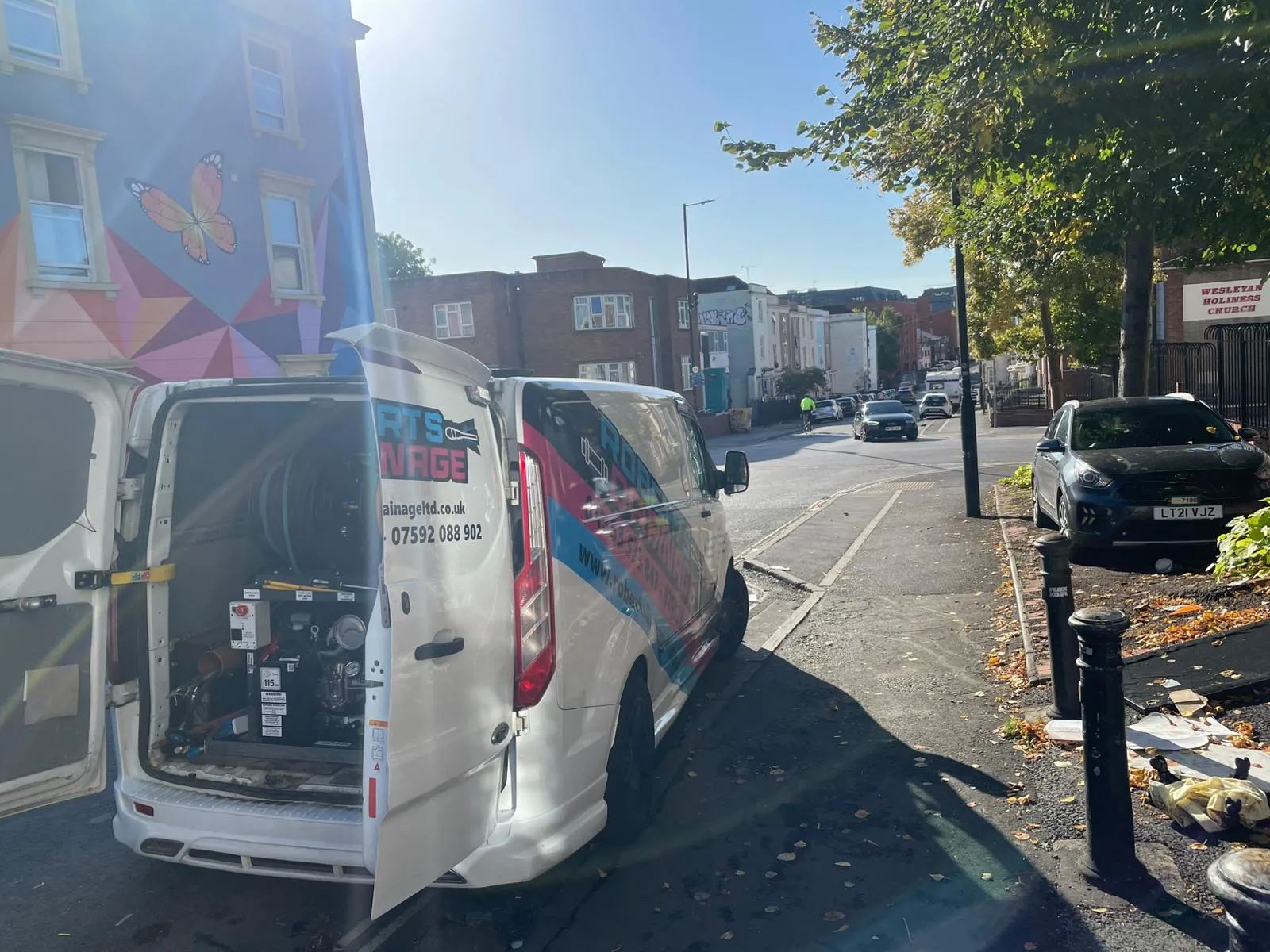 Roberts Drainage Ltd service van with high-pressure water jetting equipment parked on a street.