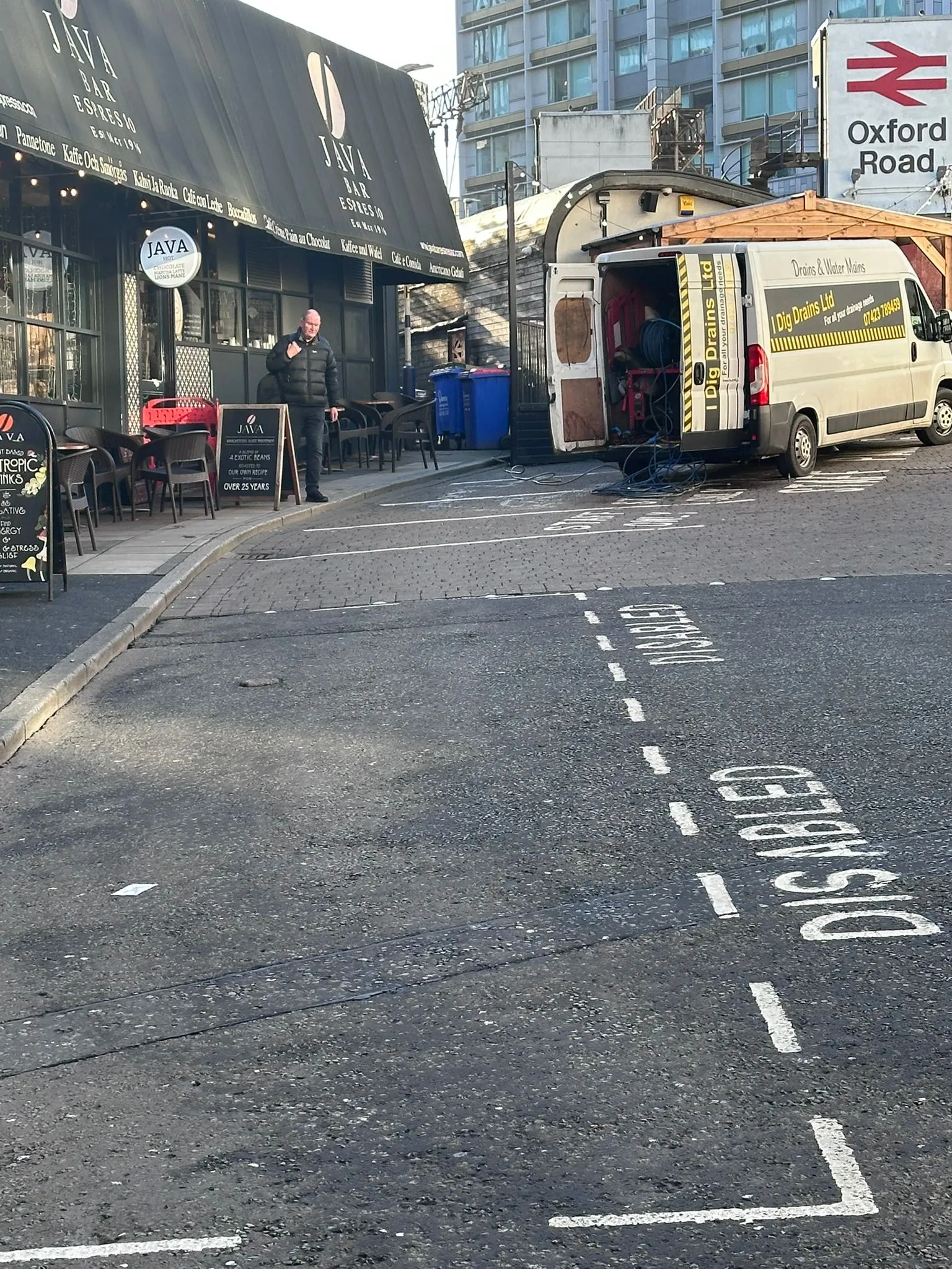 I Dig Drains Ltd van providing commercial drainage services outside a cafe in the Cheshire area.