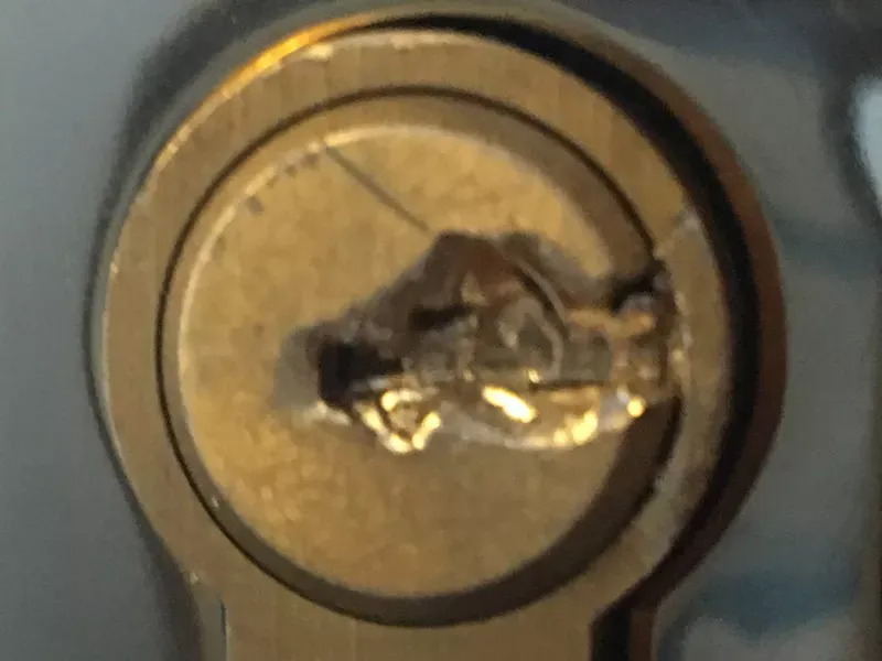 Broken key snapped in a door lock cylinder needing extraction.