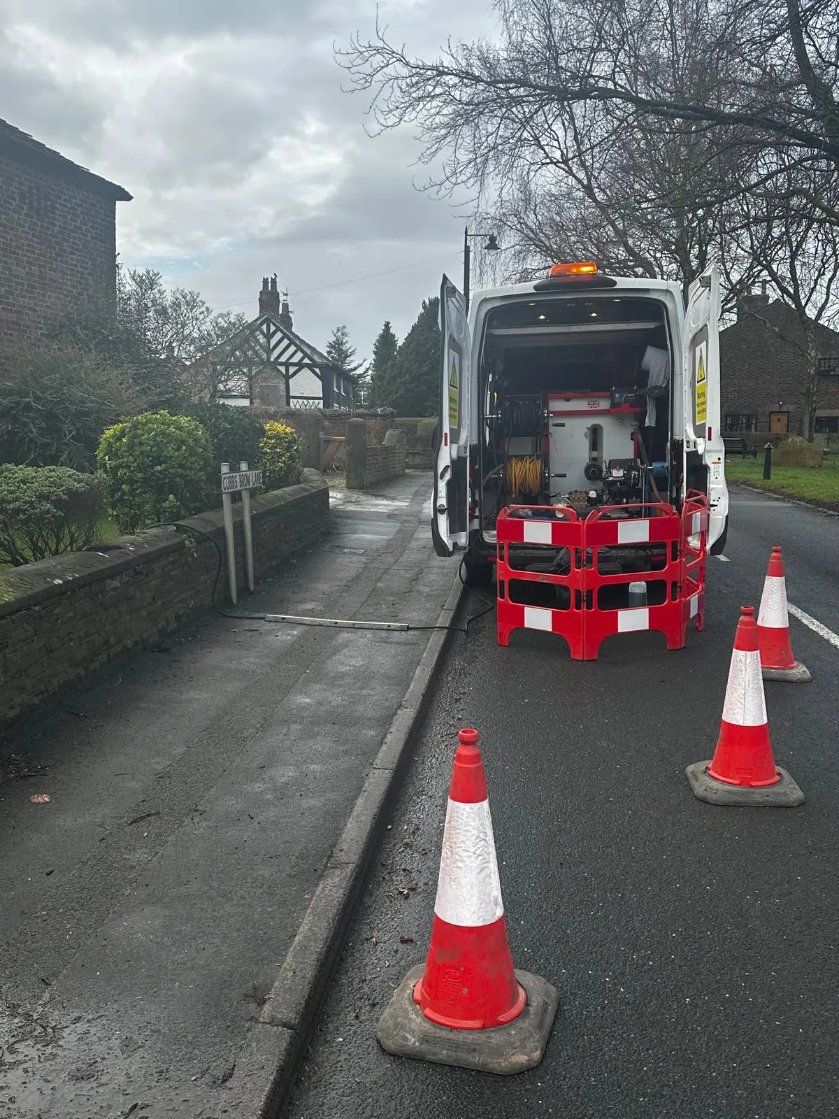 Drain Magic LTD van parked on Cobbs Brow Lane, with drainage equipment visible, ready for or in the process of drain unblocking or inspection.
