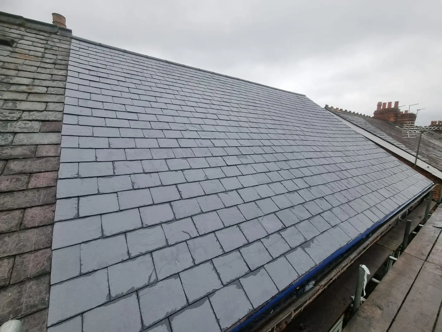 A picture of a newly installed slate roof by RM & SON ROOFING & PROPERTY CARE
