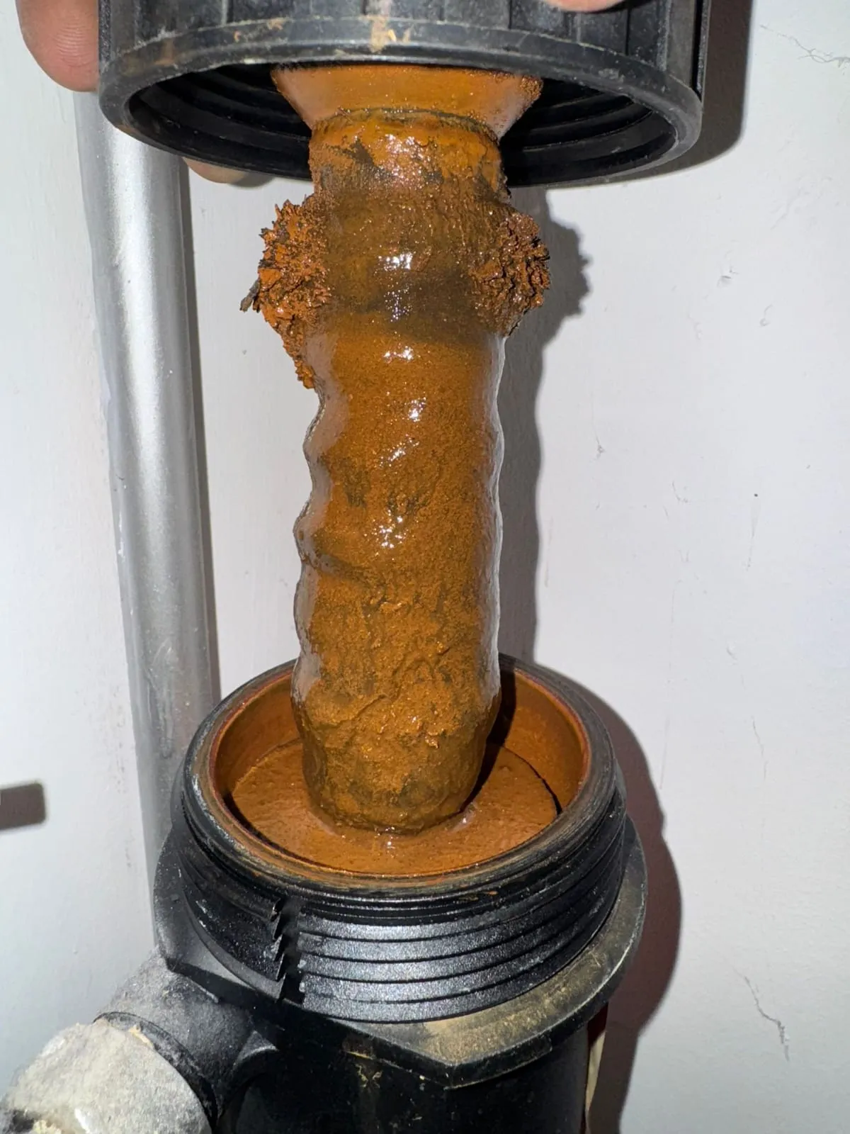 Magnetic heating system filter clogged with iron oxide sludge during boiler servicing