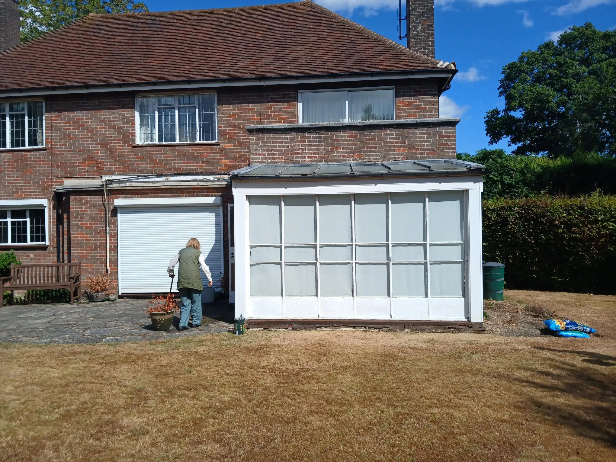 Pitched plain tiled roof and chimney stack on a red-brick residential property