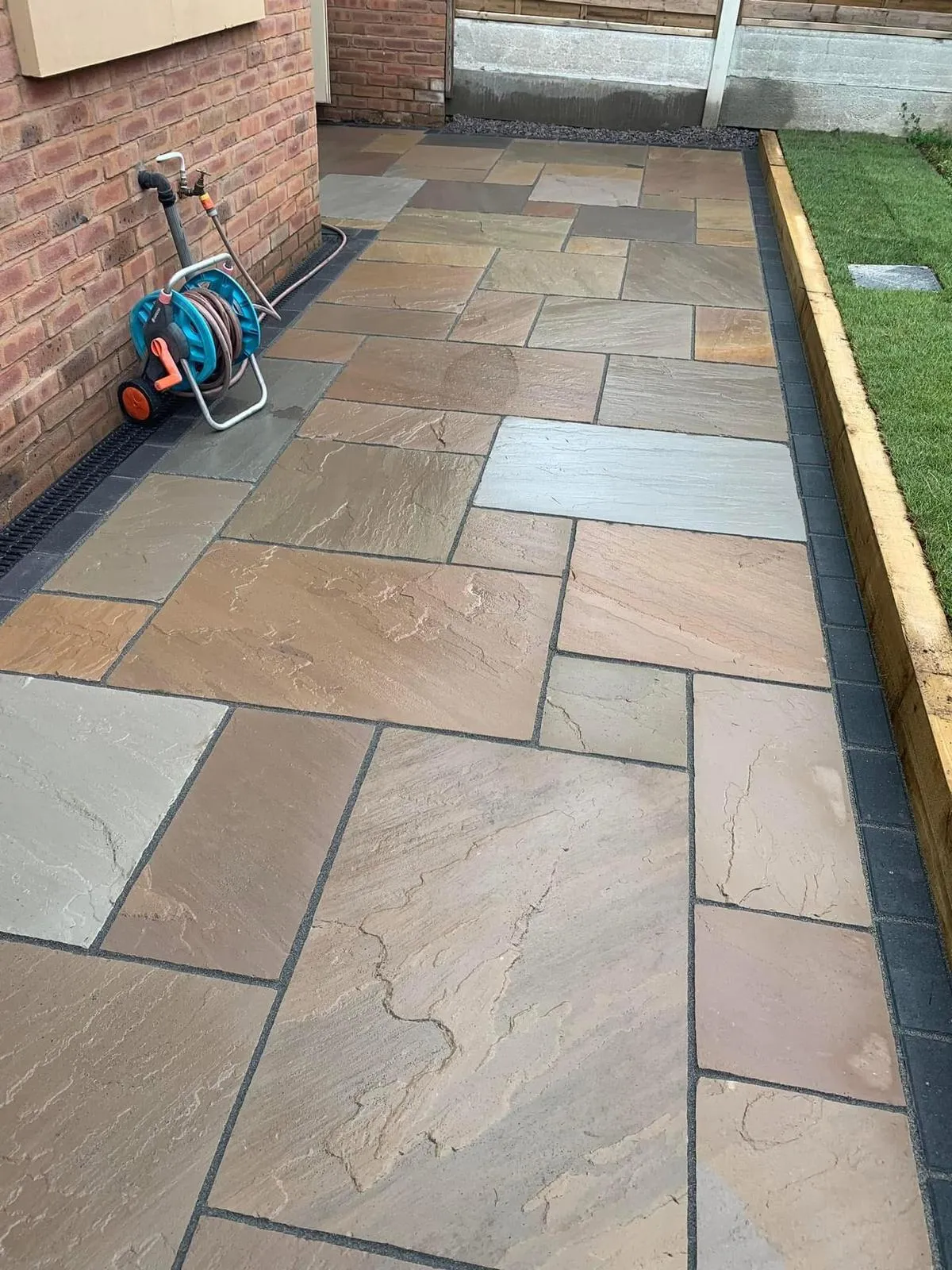 Professional Indian sandstone paving installation with block paving borders and garden landscaping in Kent.