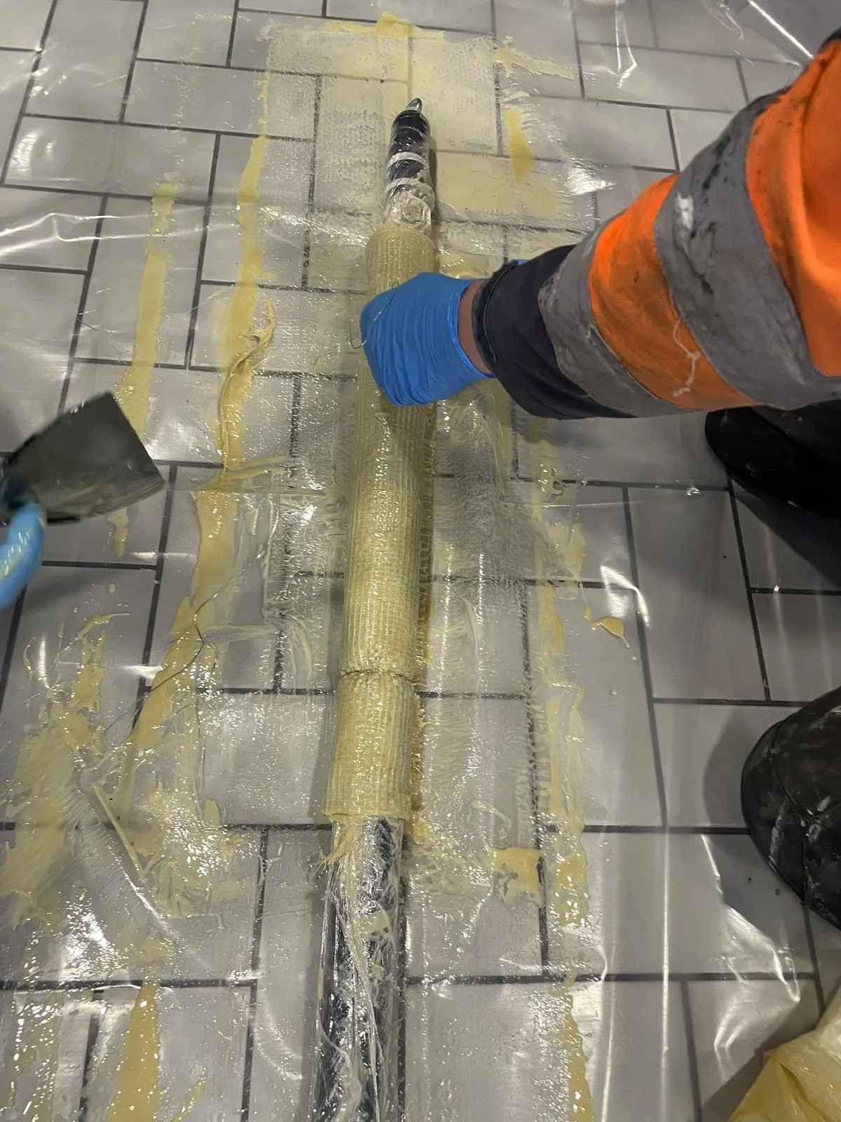 Technician preparing a patch liner for no-dig drain repair