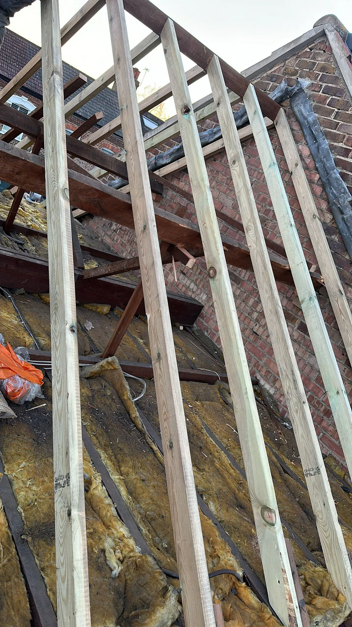 New treated structural timber roof rafters installed during roof repair work